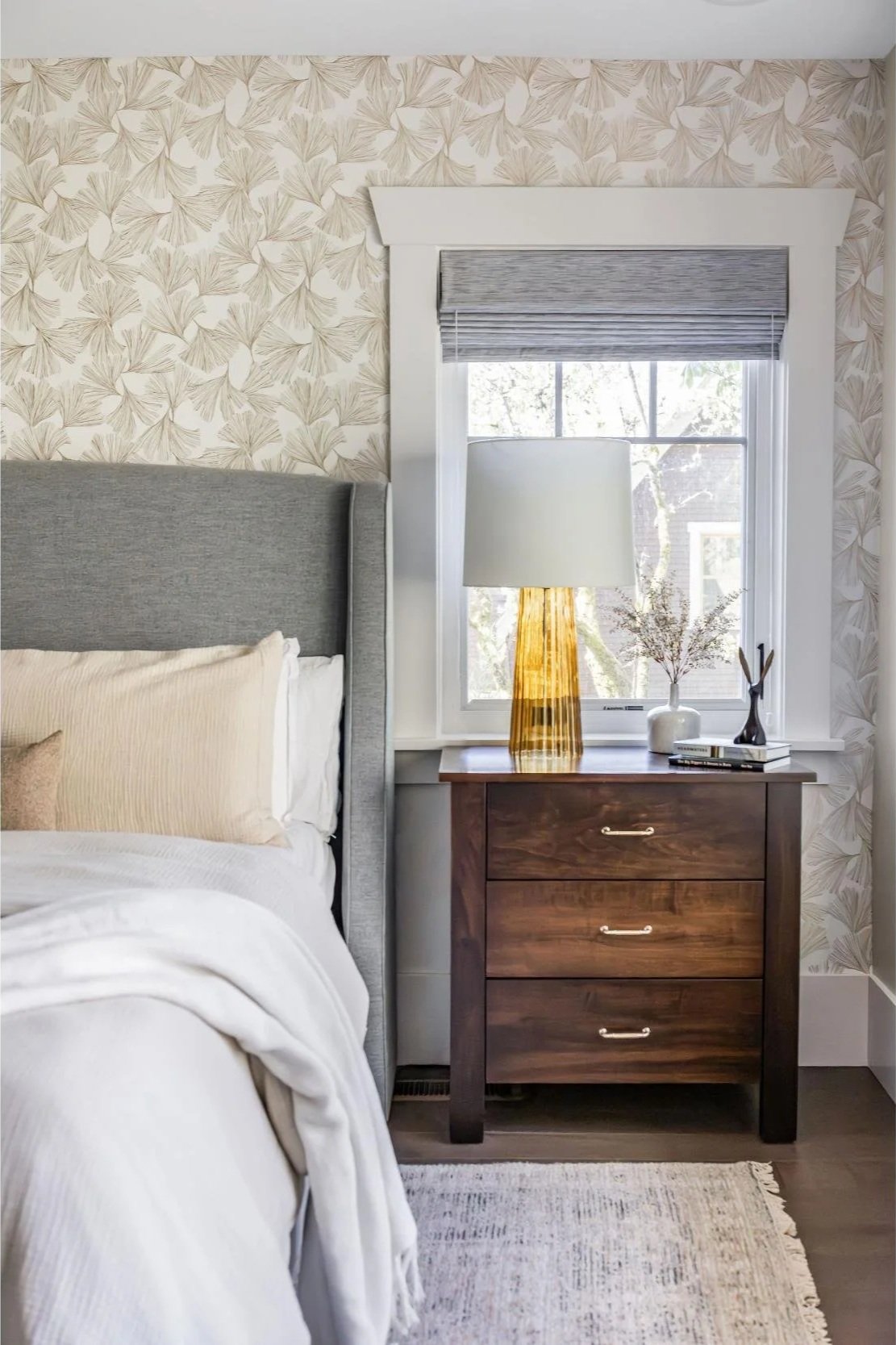 Home addition with bedroom with wallpapered walls and wood flooring