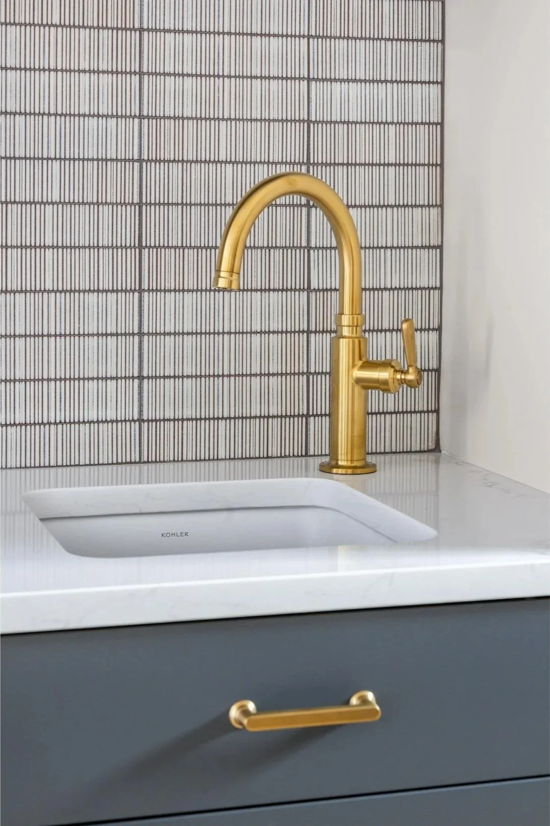Brass faucet and white tile for bar