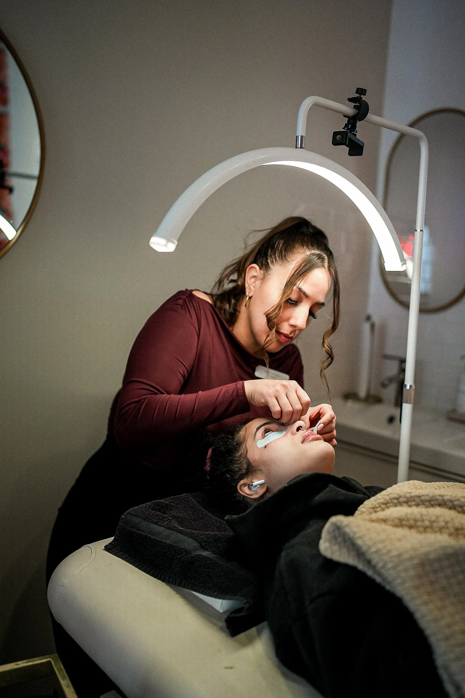 Technician applying lash extensions to client