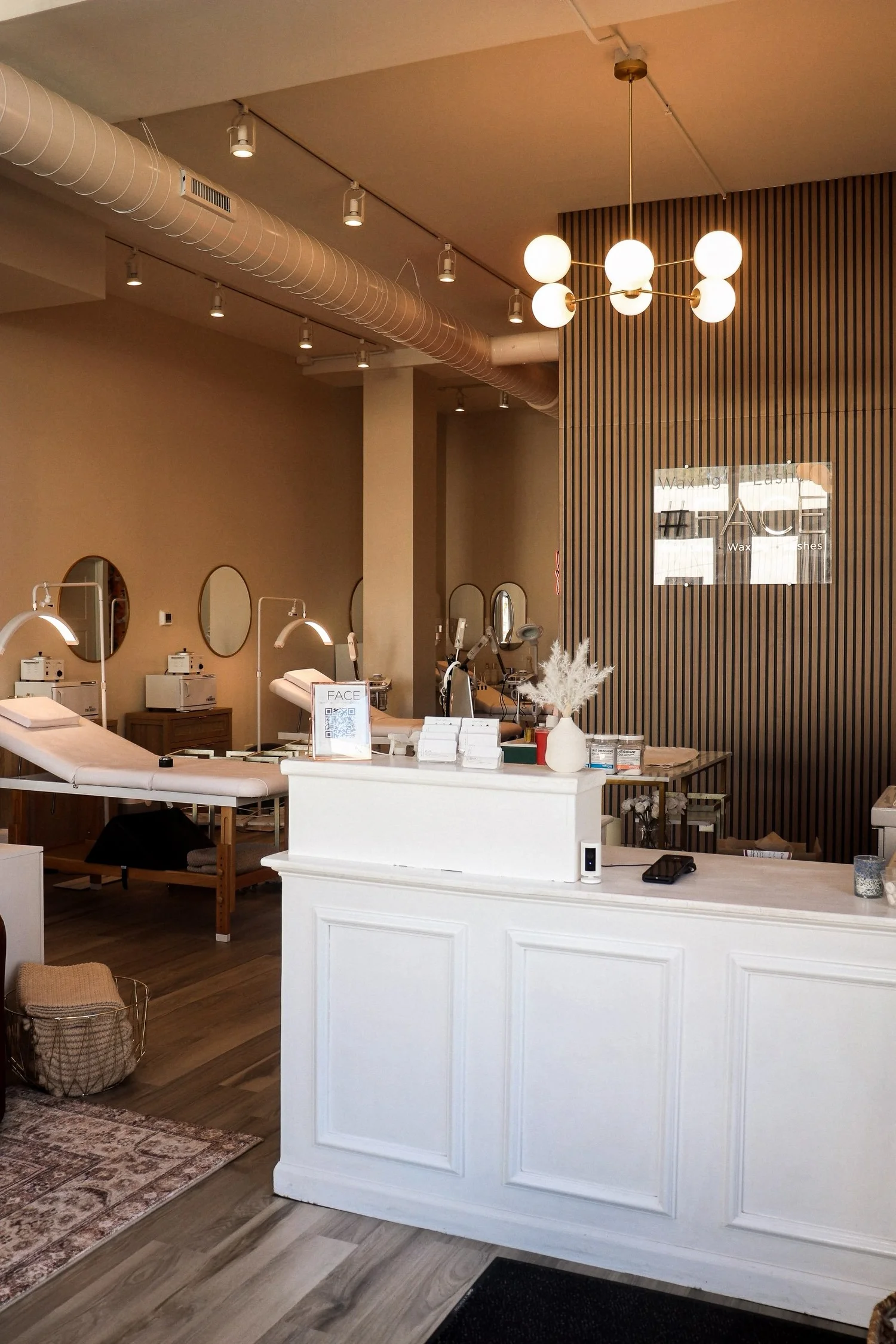 Reception desk and treatment area of the salon