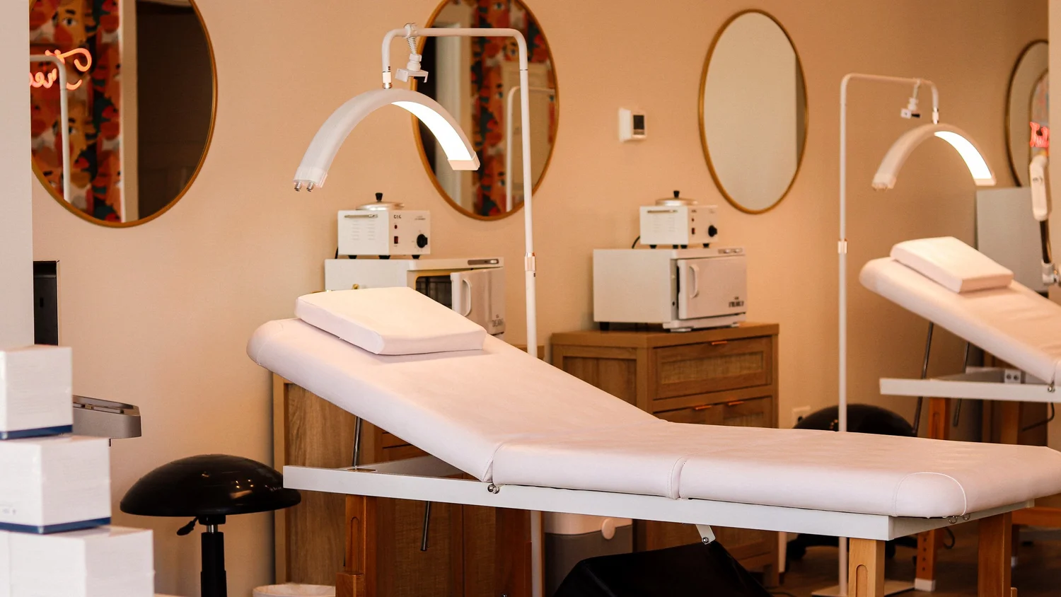 Treatment beds and lamps in a warm-toned room