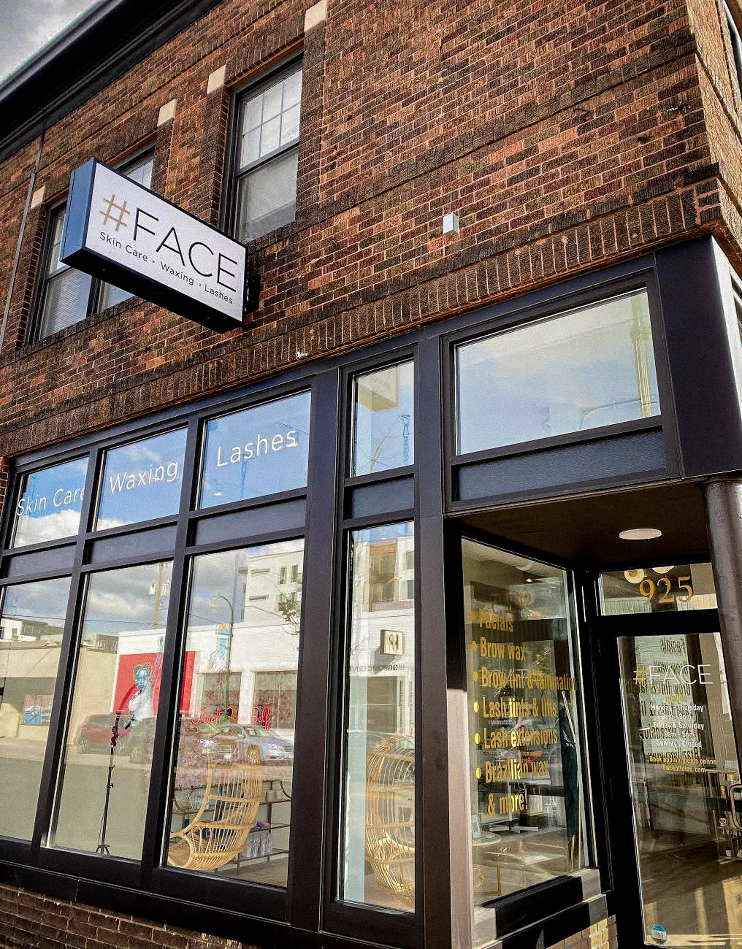 Storefront with #FACE sign on brick building