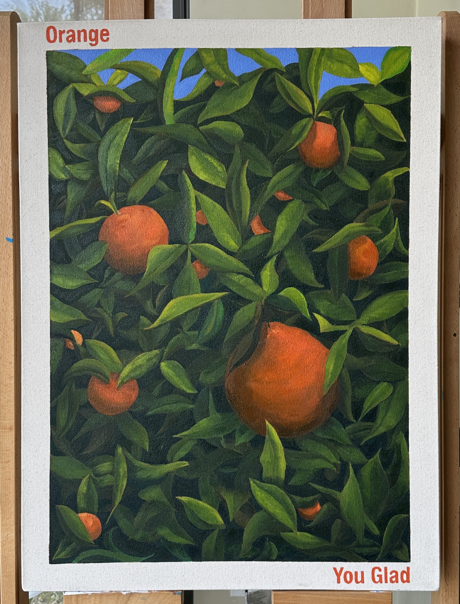 A painting of orange fruit on a tree with green leaves and a bright blue sky background, labeled with the words 'Orange' in red at the top and 'You Glad' in red at the bottom.