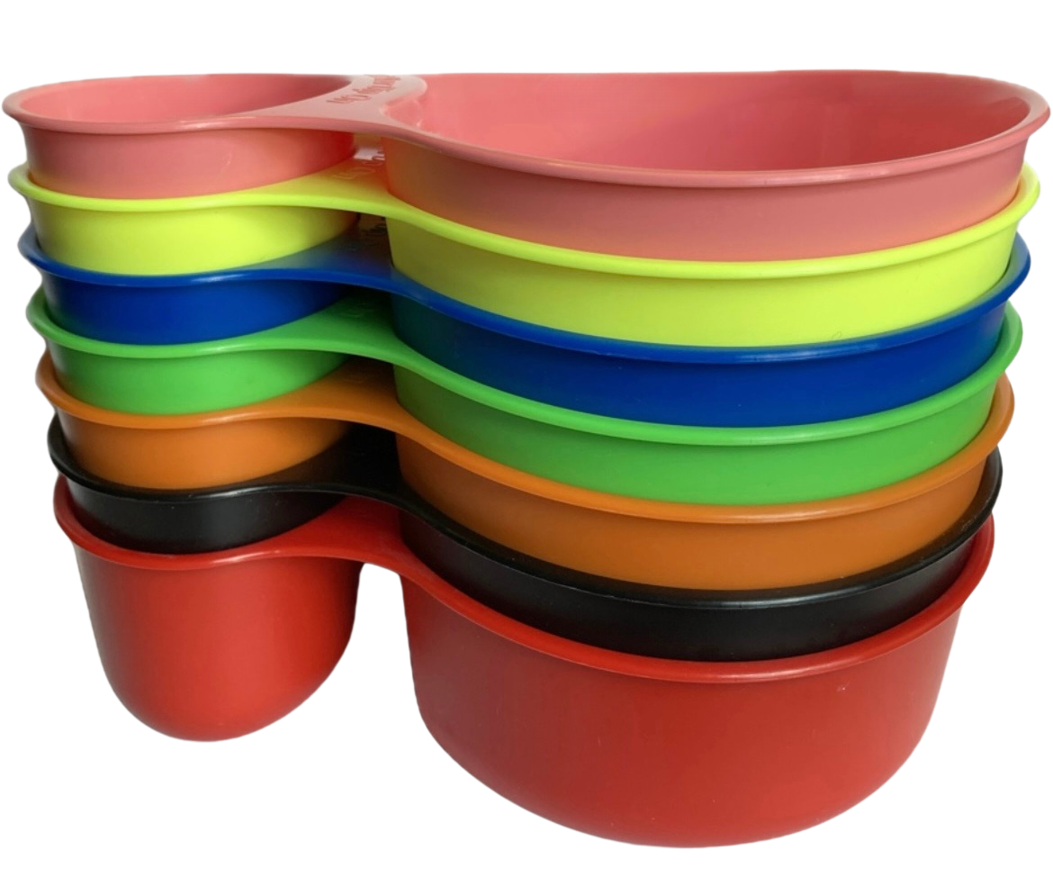 Stacked colorful plastic bowls in pink, yellow, blue, green, orange, black, and red.