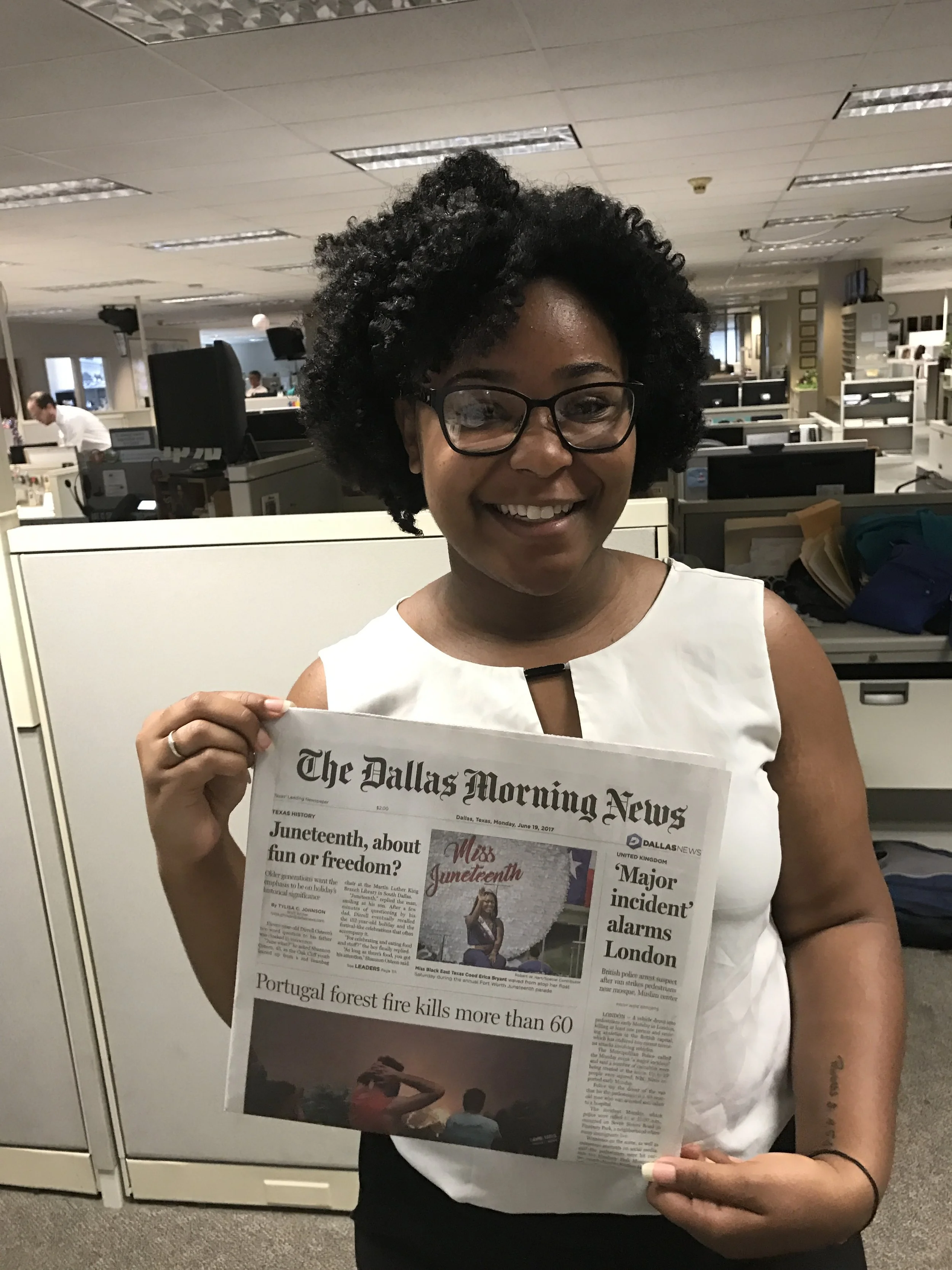 TyLisa holding one of her front page stories at The Dallas Morning  News
