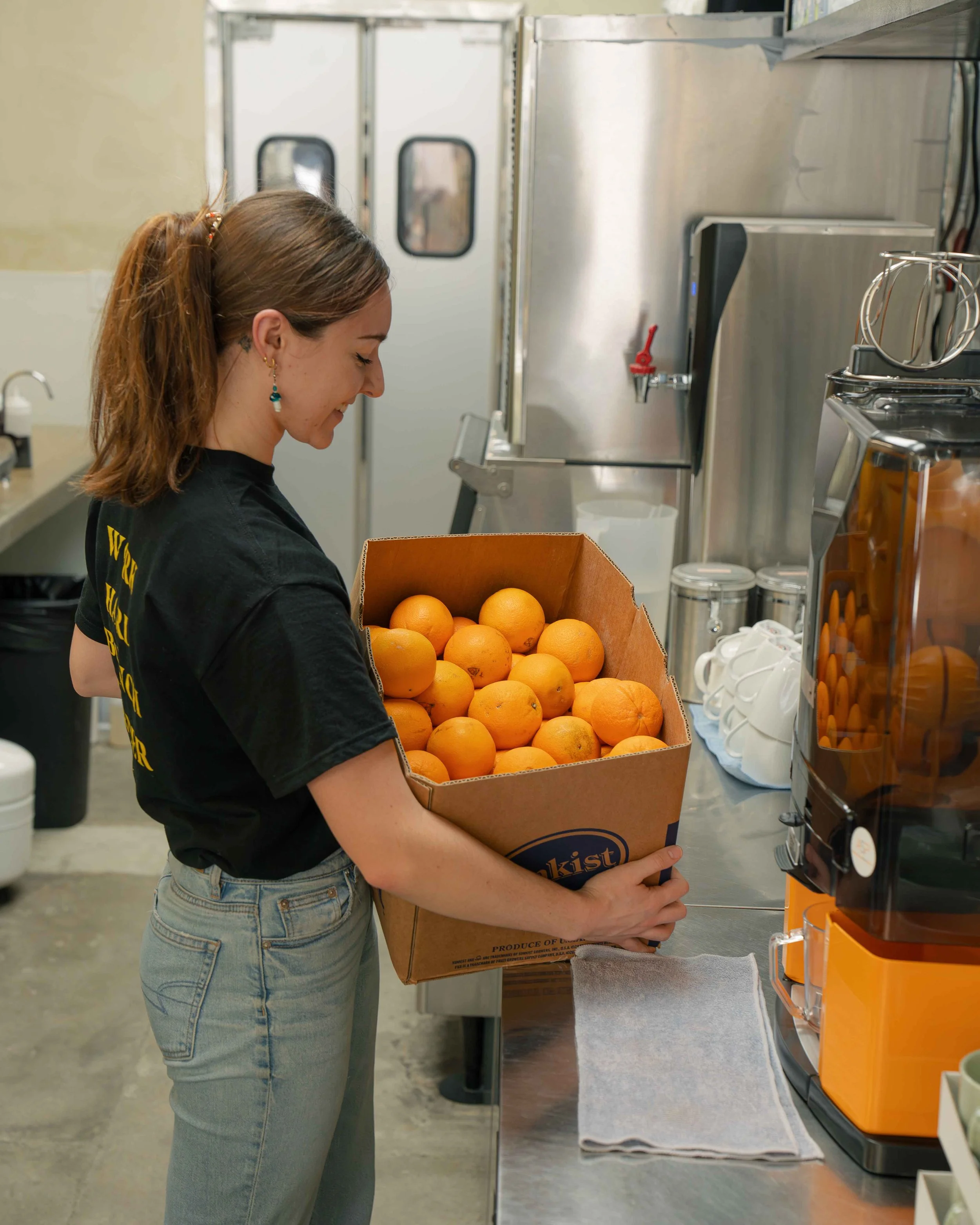 Staff getting fresh oranges to make juice
