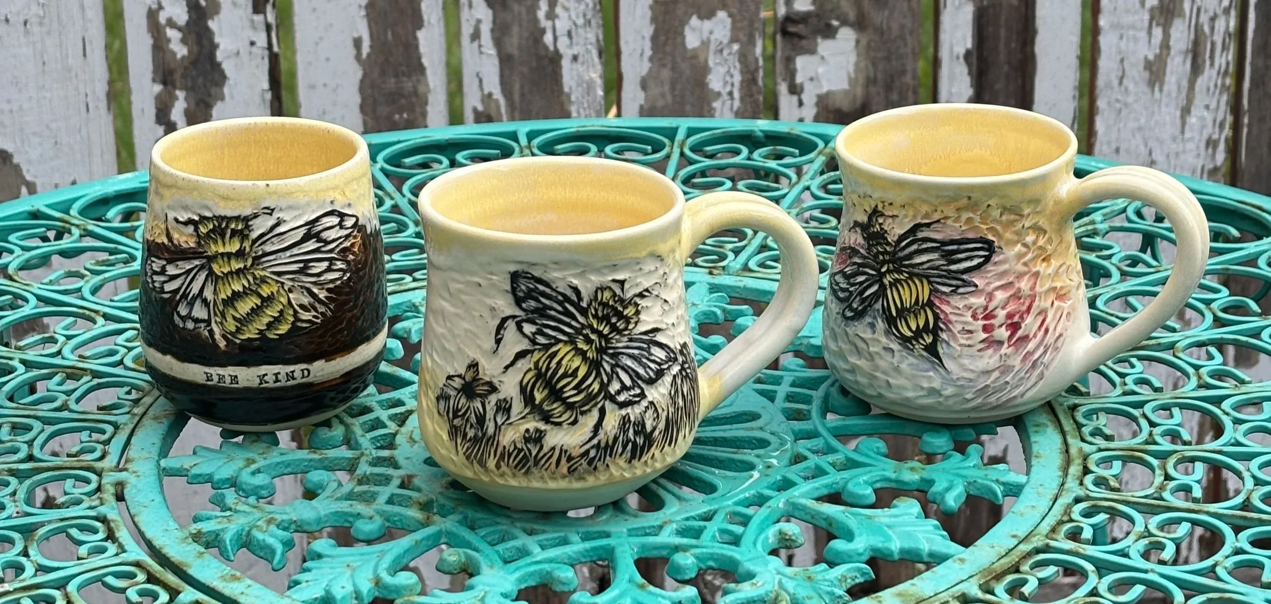 Three ceramic Radiomud cups with bee designs