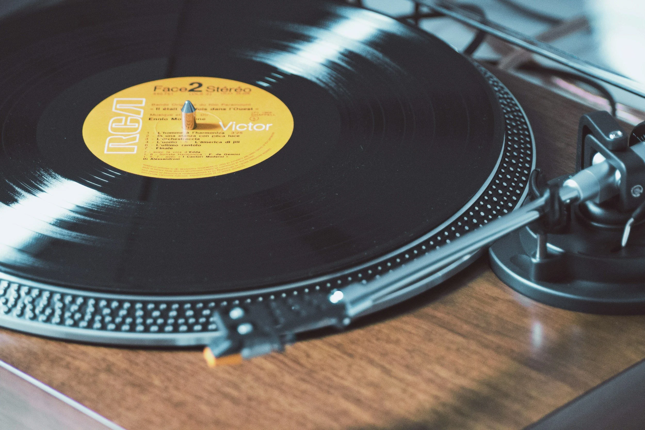 Close-up of a vinyl record on a turntable with a yellow label.