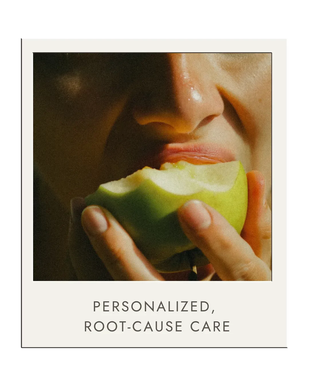 Close-up of a person about to bite into a green apple, with a caption that reads "Personalized, Root-Cause Care."