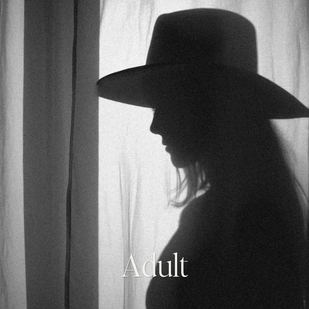 Silhouette of a woman wearing a wide-brimmed hat facing a window with the word "Adult" overlayed.