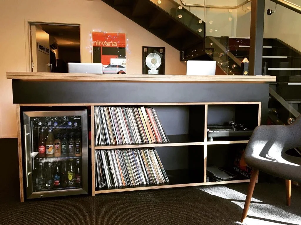 Black Futura Plywood Front Desk and integrated mini fridge / Franklin Road, 2016.