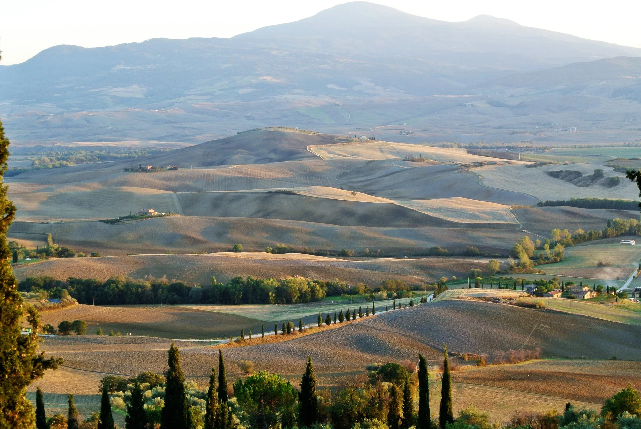 Pienza in the Val d'Orca region of Tuscany, Italy with terrain dotted rolling hills and farmland in a clear day in September