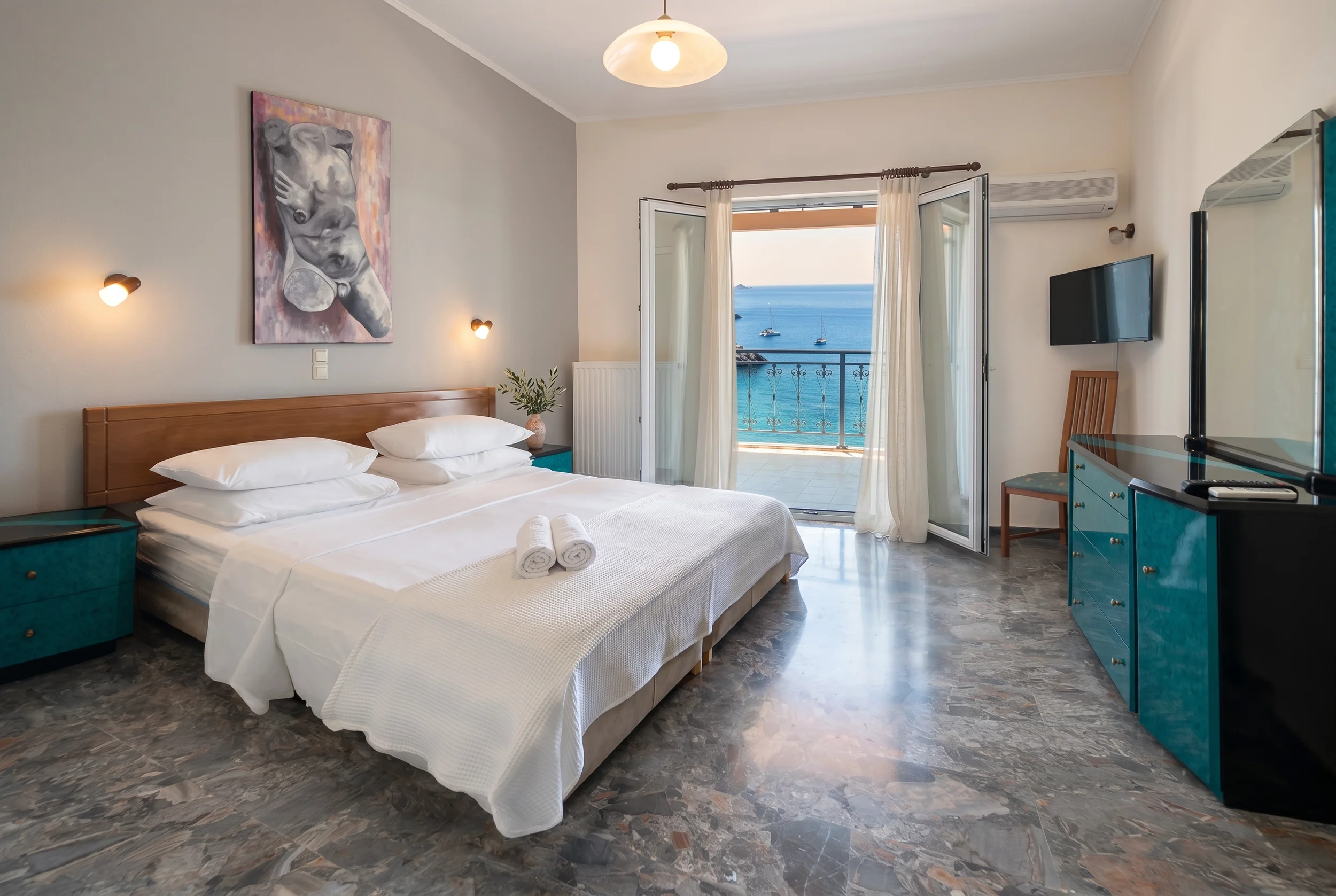 Modern sea view bedroom with a private balcony at Platakia Blu, featuring panoramic views of the Ionian Sea in Corfu.