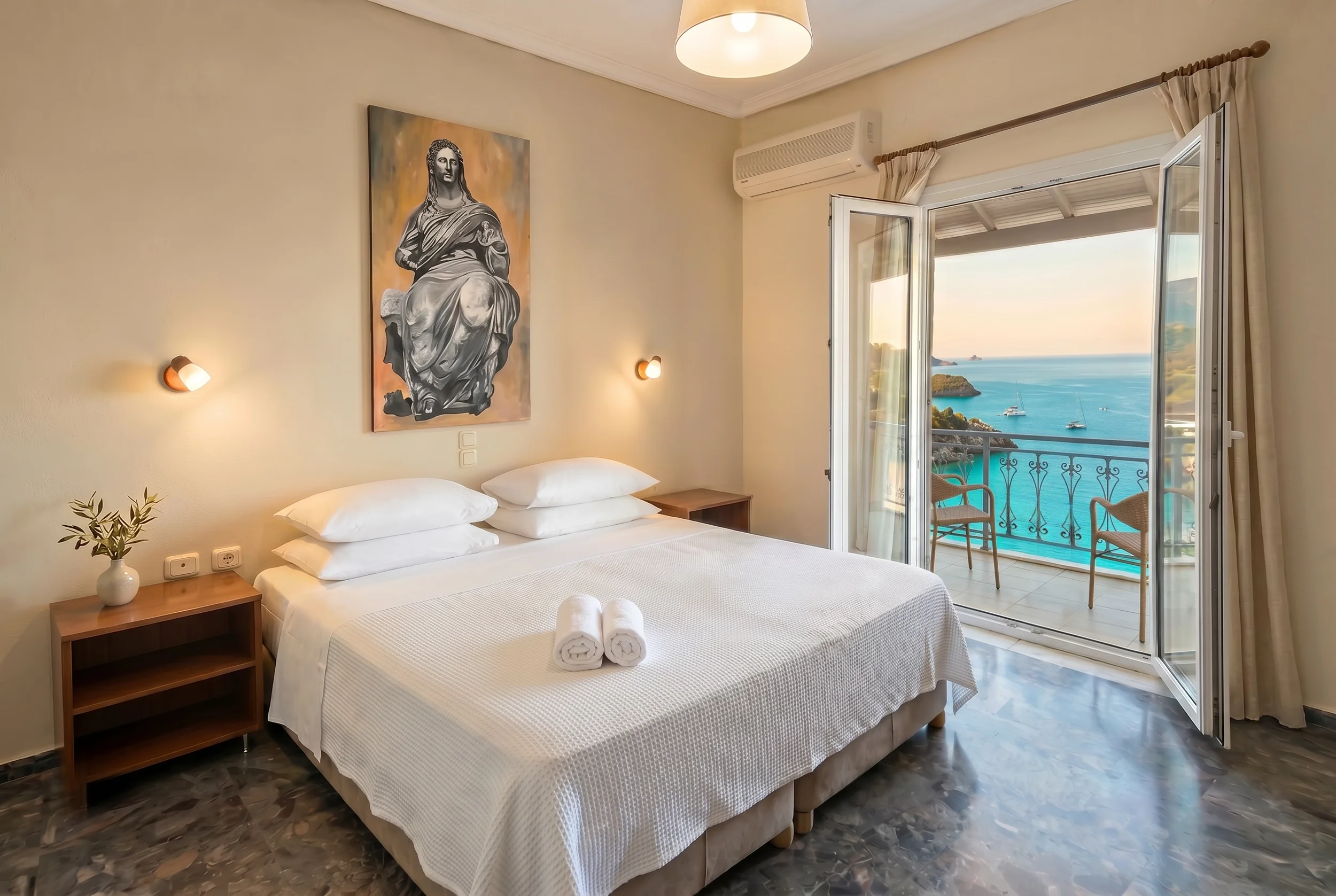 Oceanfront bedroom with a comfortable double bed and balcony overlooking the Ionian Sea in Paleokastritsa, Corfu.