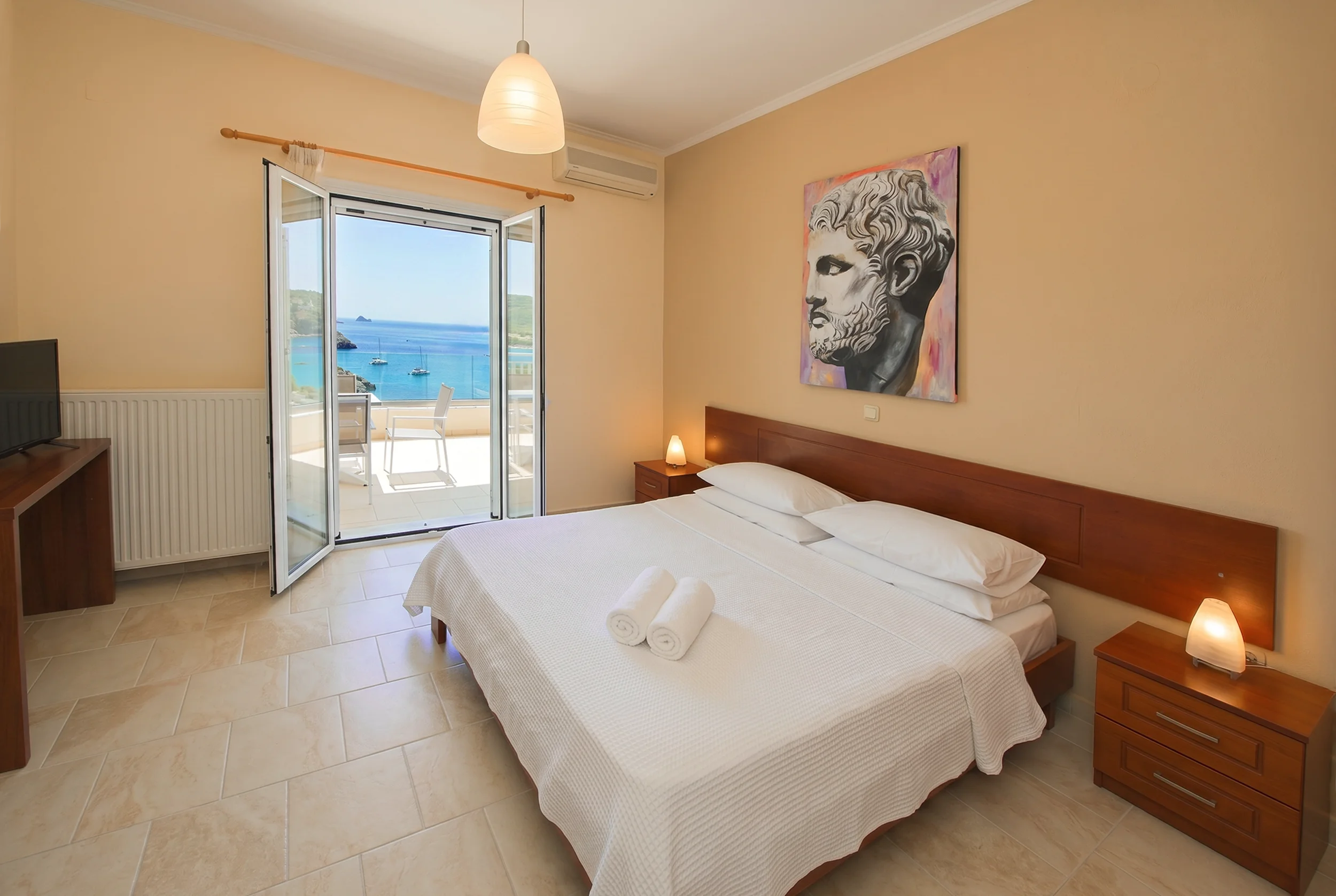 Sea view bedroom with a double bed and private balcony overlooking the Ionian Sea at Platakia Blu in Paleokastritsa, Corfu.