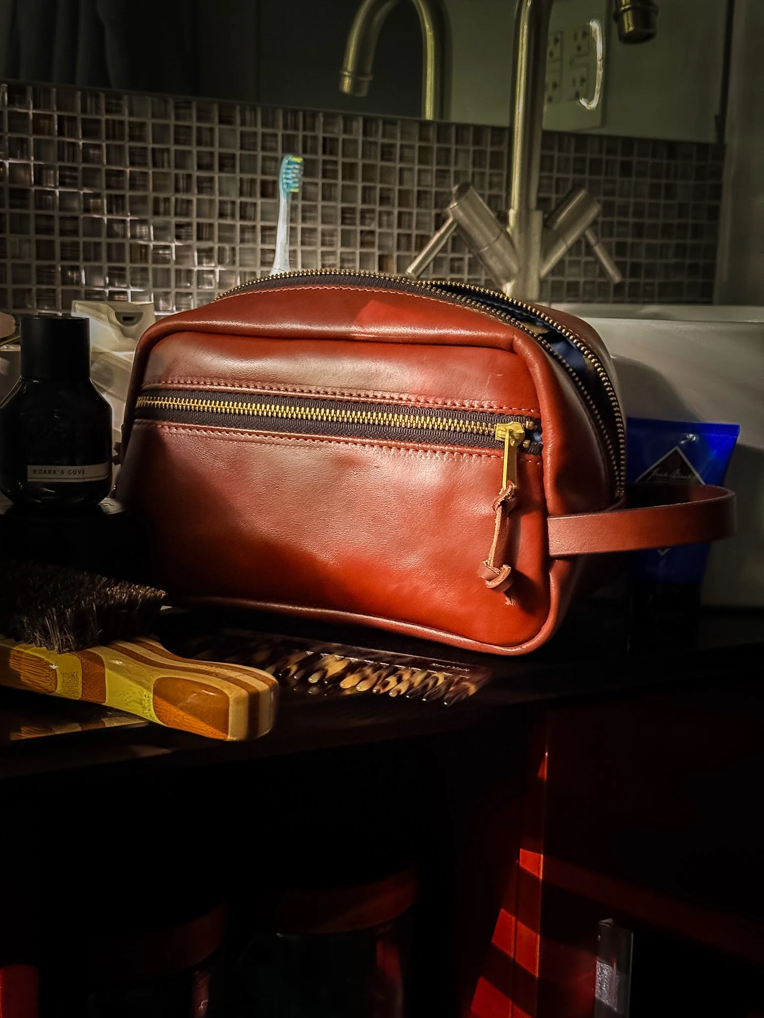A handmade rich brown dopp kit in bathroom. 