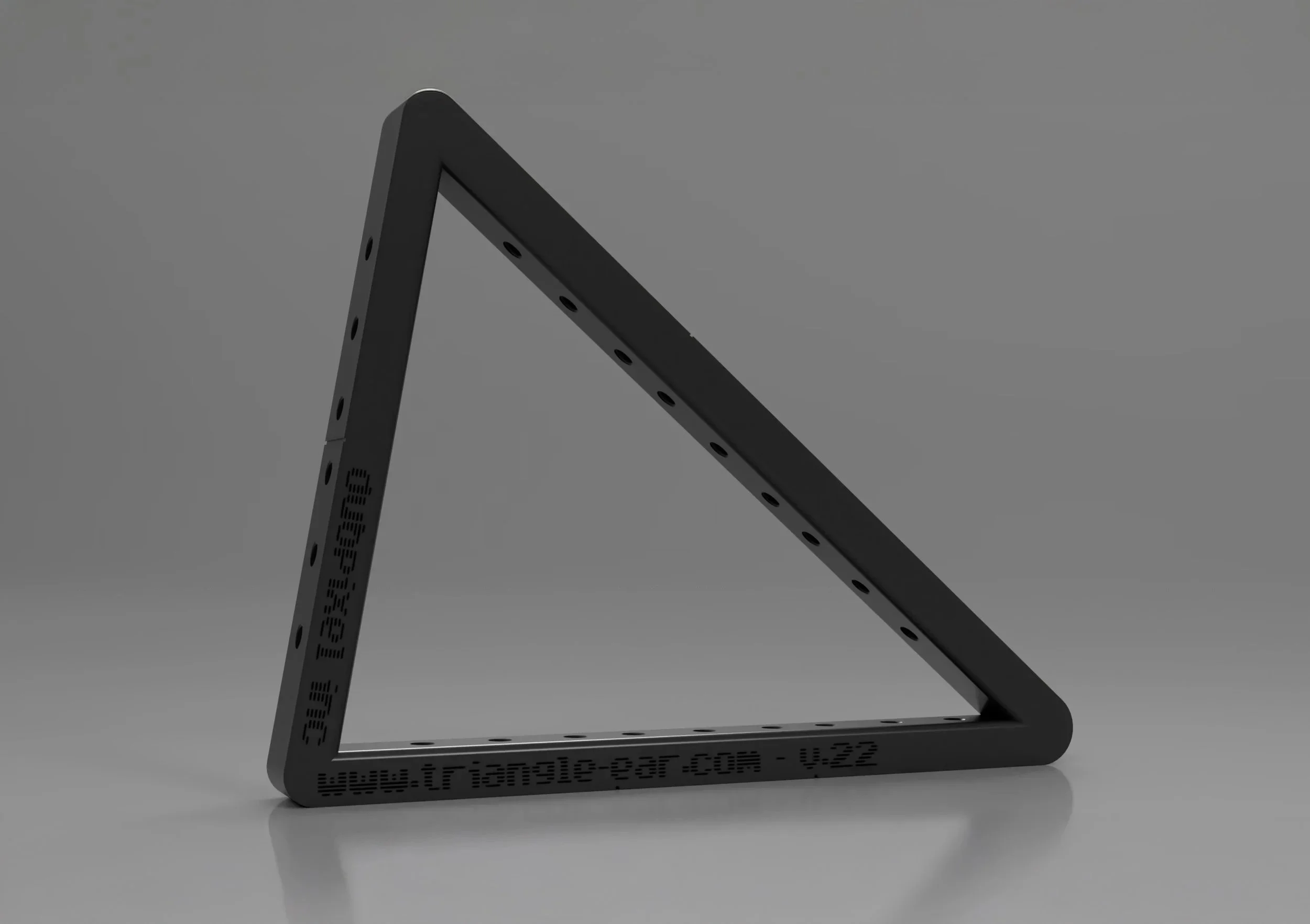 A black metal triangular frame with mounting holes and a website URL engraved on the bottom horizontal bar, set against a gray background.