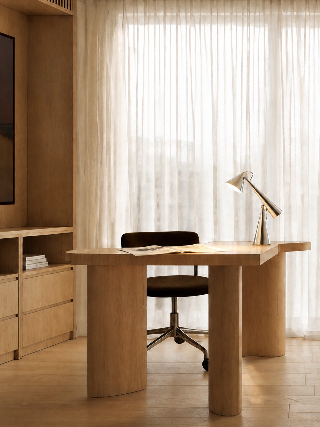 Study with a light oak desk on cylindrical legs, a chocolate velvet chair and a chrome cone lamp