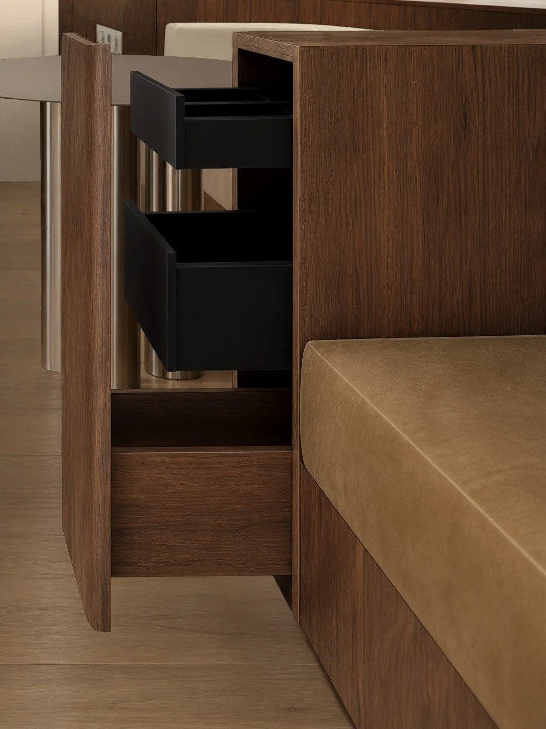 Dining banquette drawer pulled open, walnut outside and black inside, beside tan velvet seating