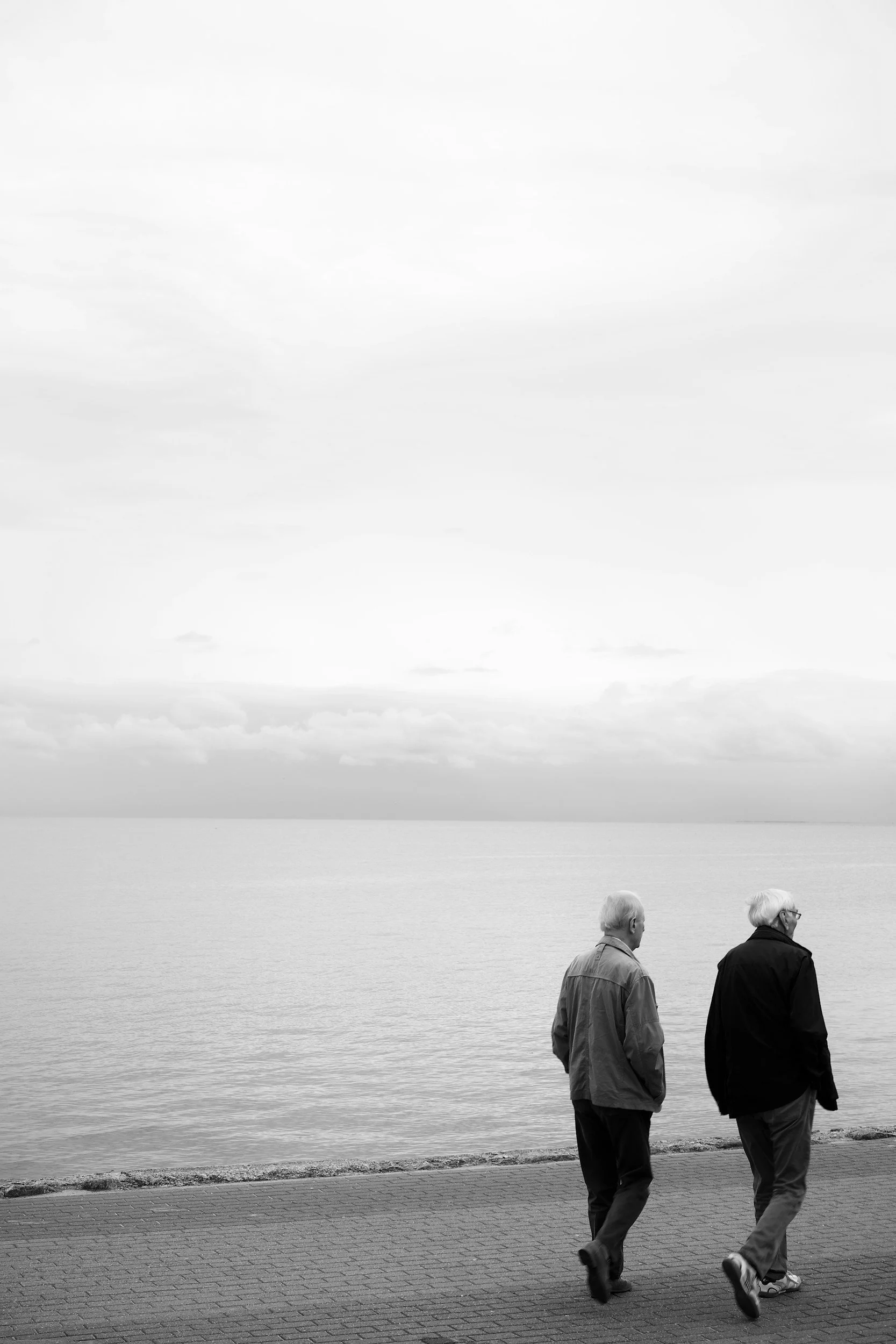 Two men walking down a beach