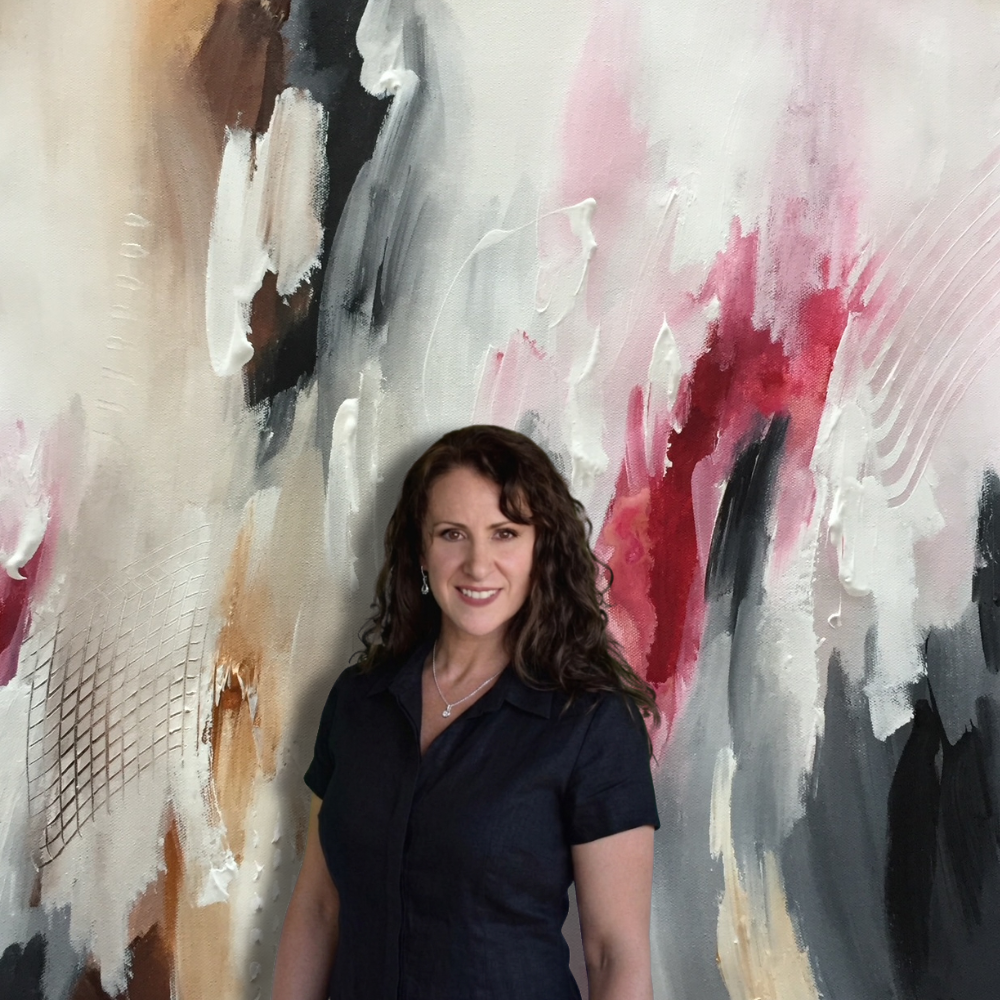 An artist standing in front of a huge abstract commissioned painting.