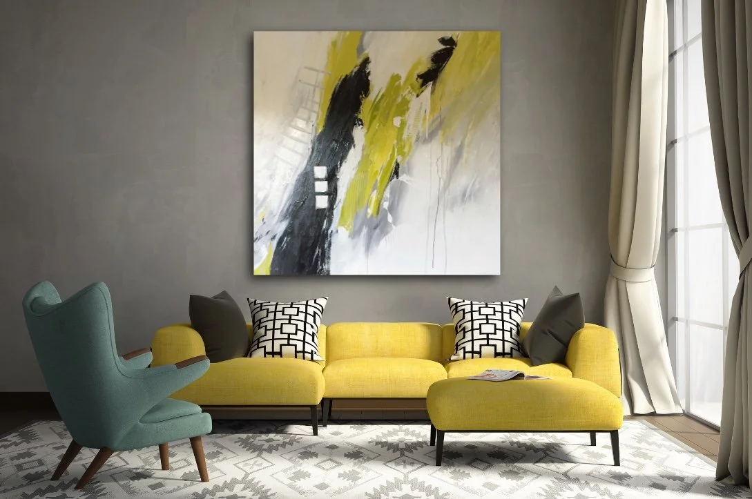 Living room with a yellow sofa, black and white patterned pillows, an abstract wall art, a blue armchair, and large windows with cream curtains.