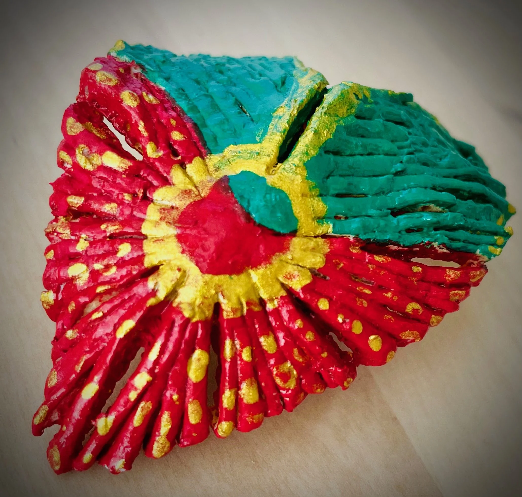 Close-up of a colorful citrus rind, with red and yellow details and a blue base.