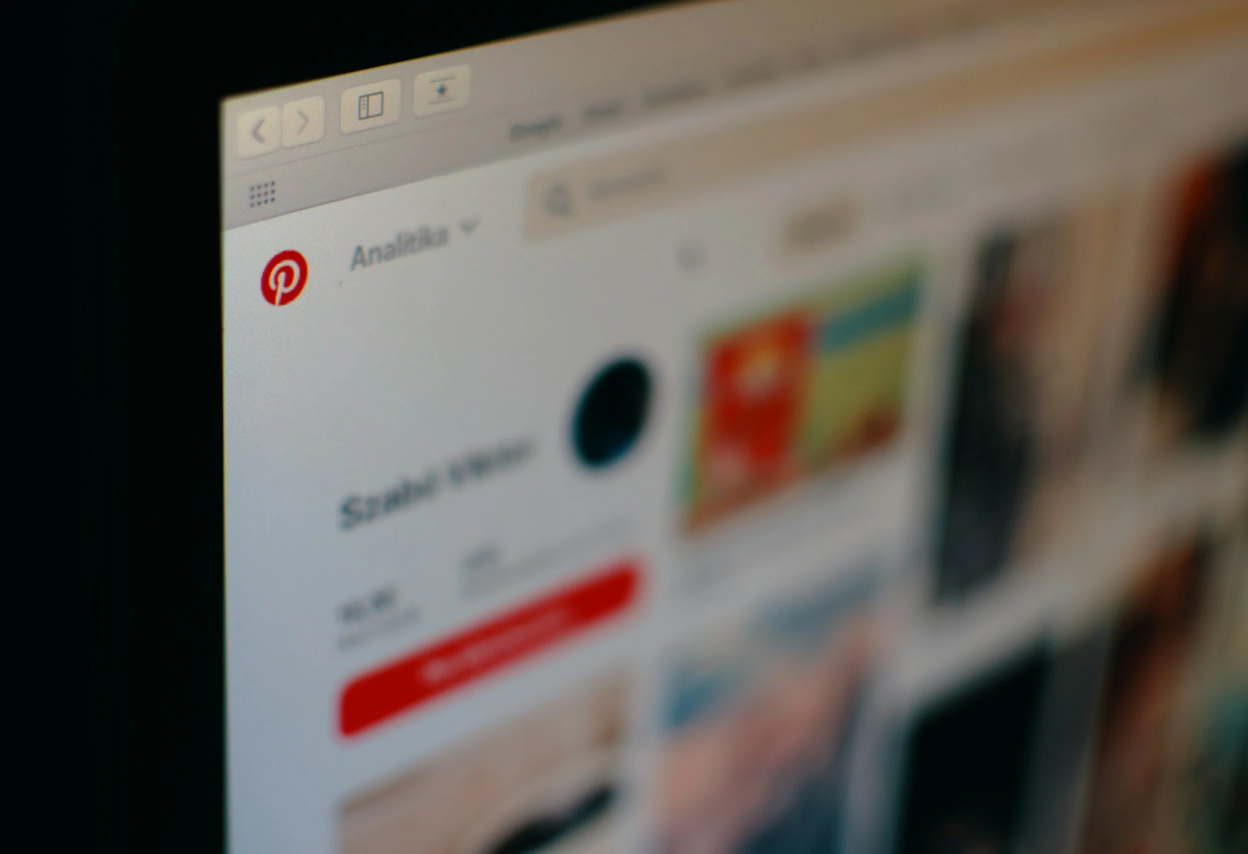 Close-up of a computer screen displaying the Pinterest website, focusing on the website's logo with a red background and a white stylized 'P' icon.