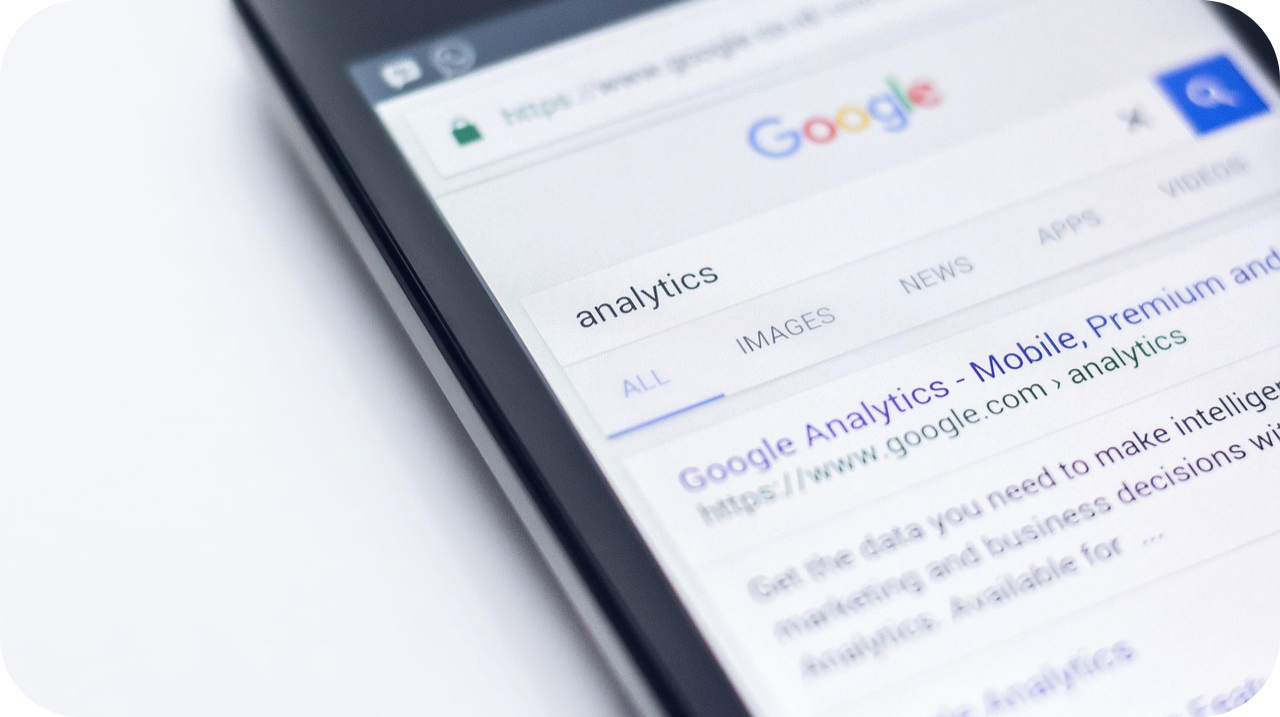 Smartphone displaying a Google search results page for 'analytics' with a highlighted link to Google Analytics.