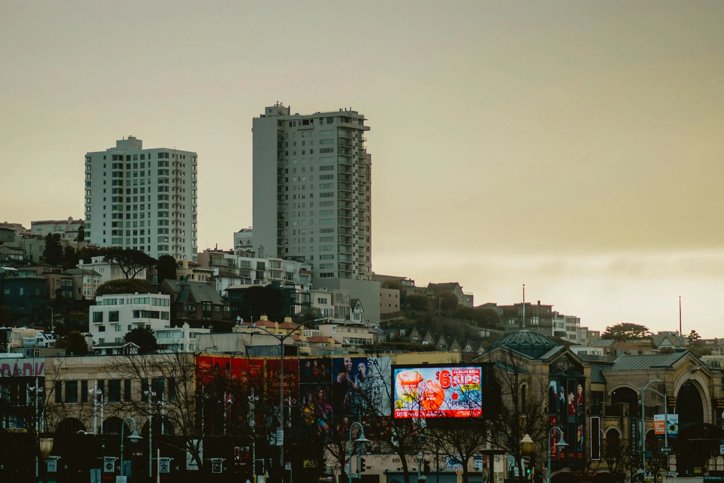 city skyline with gray sky with a digital billboard in the foreground