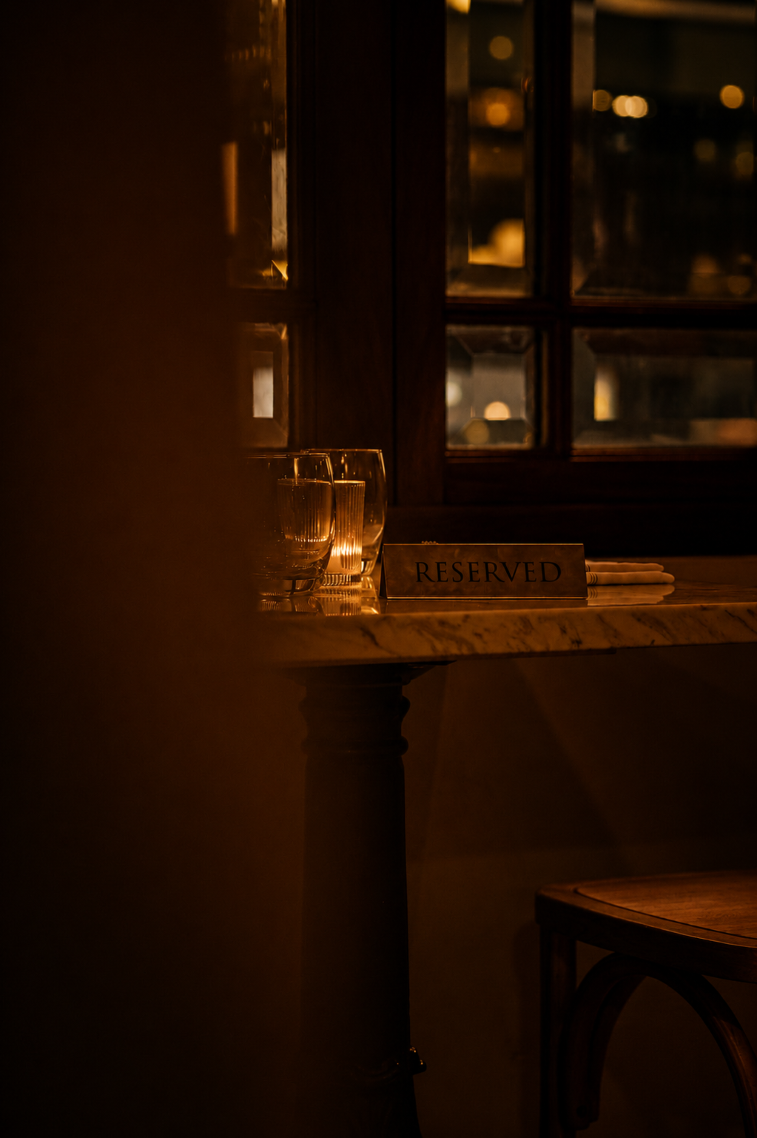 Reserved table at Pattin' NYC restaurant, Theatre District Manhattan, warm candlelit dining room.