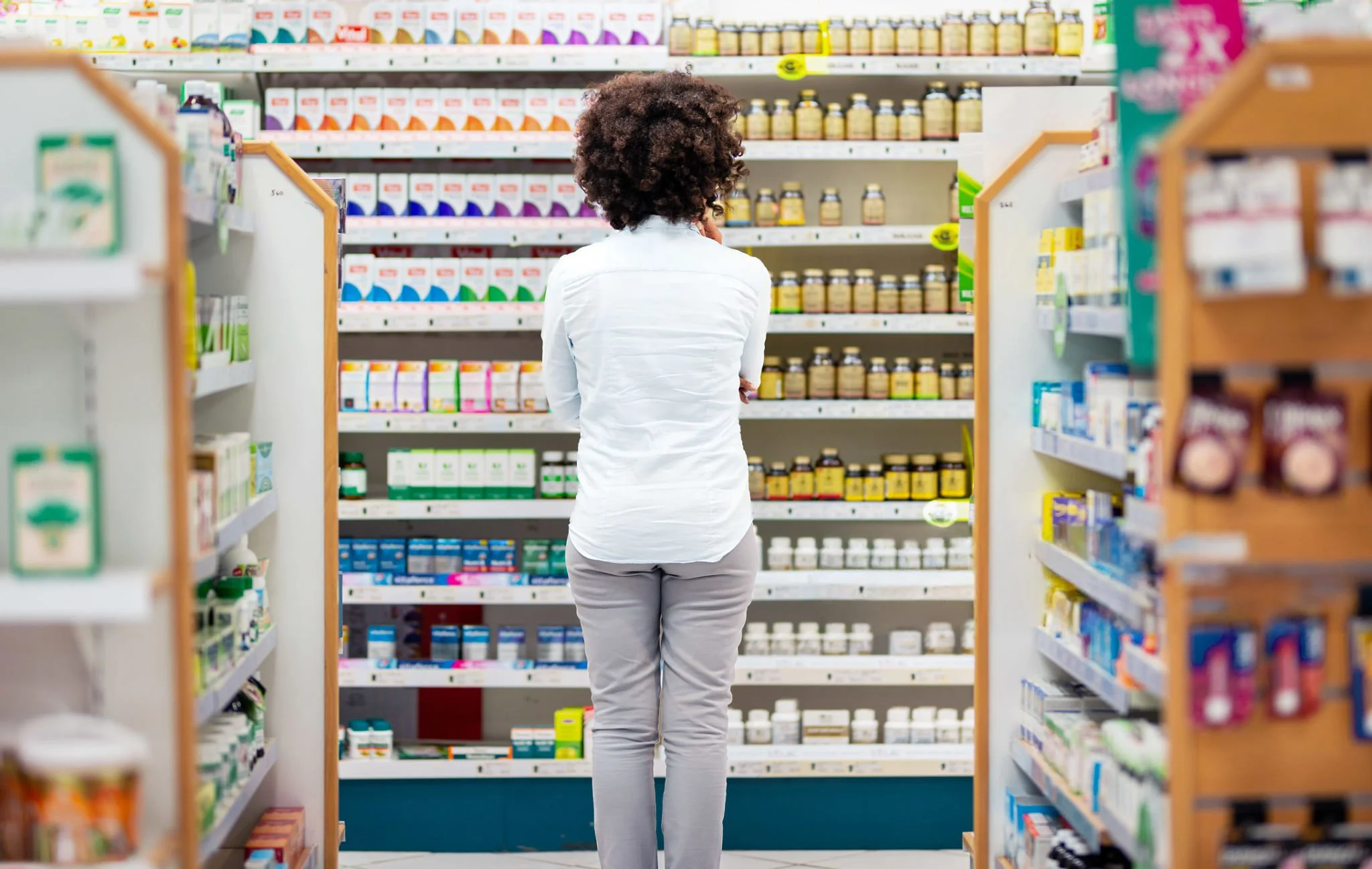 Pharmacist managing front-of-store product range with Worldsmart retail technology