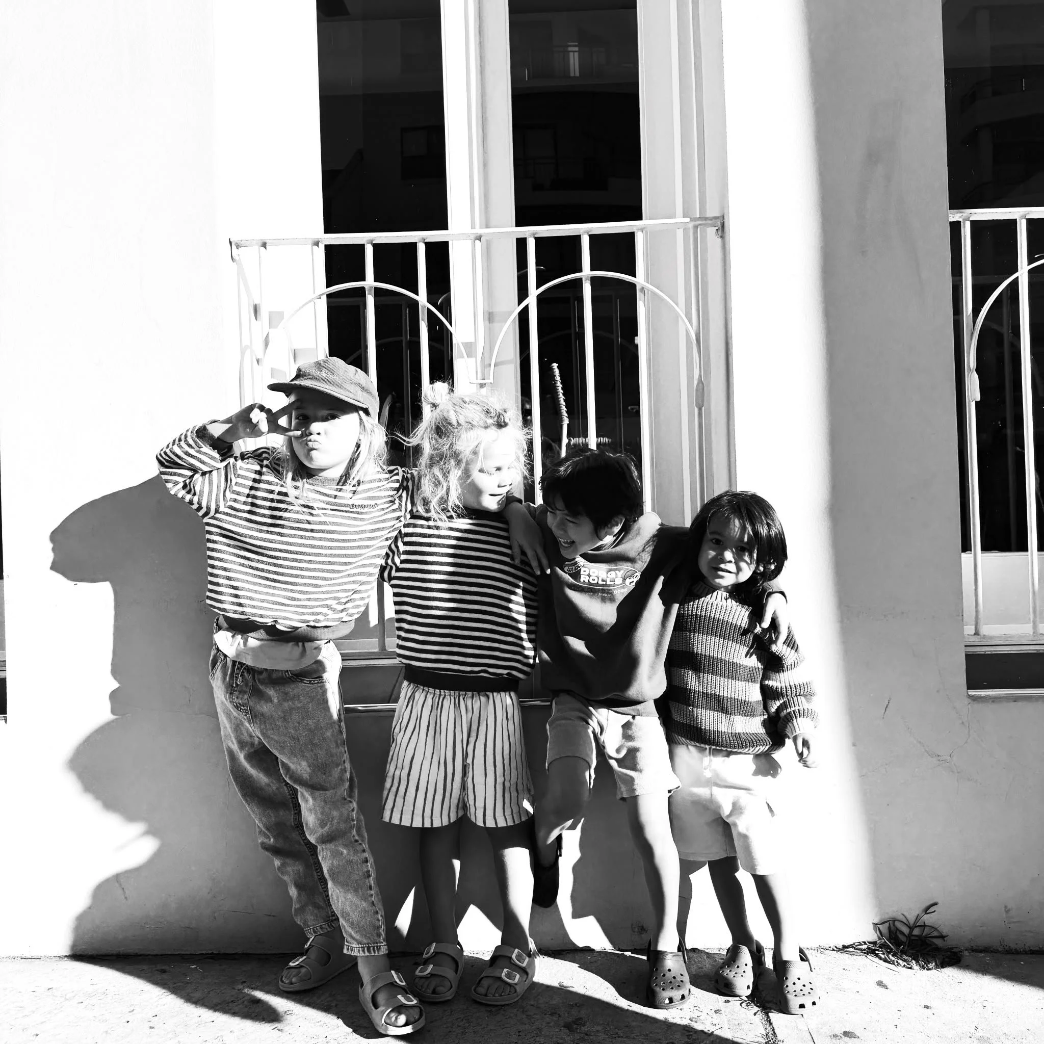 Black and white image of 4 young kids