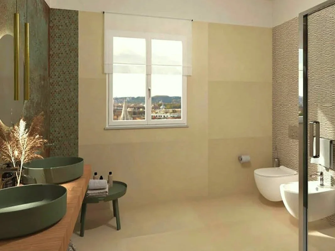 Une salle de bain moderne avec deux vasques ovales vertes, un miroir, une fenêtre avec vue sur la ville, et un espace avec toilette et bidet, éléments de décoration naturels.