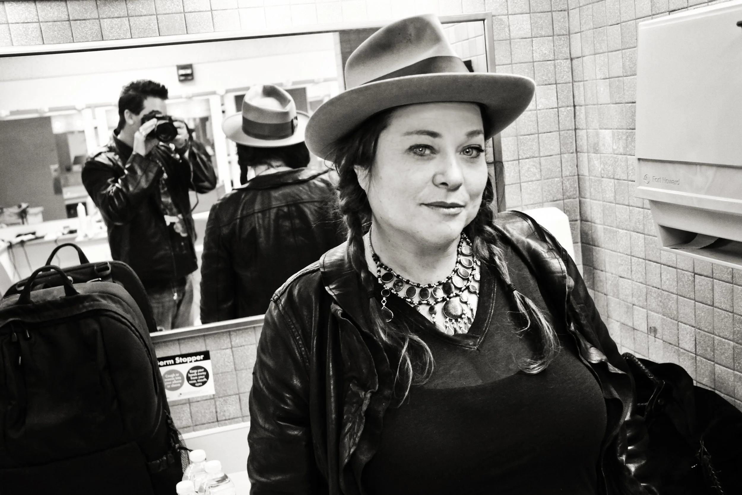 Black-and-white portrait of Shilah Morrow, affectionately known as Mama Shi, photographed backstage during Christopher Durst's years documenting music culture. The image captures a candid moment of friendship, connection, and lasting creative bonds.