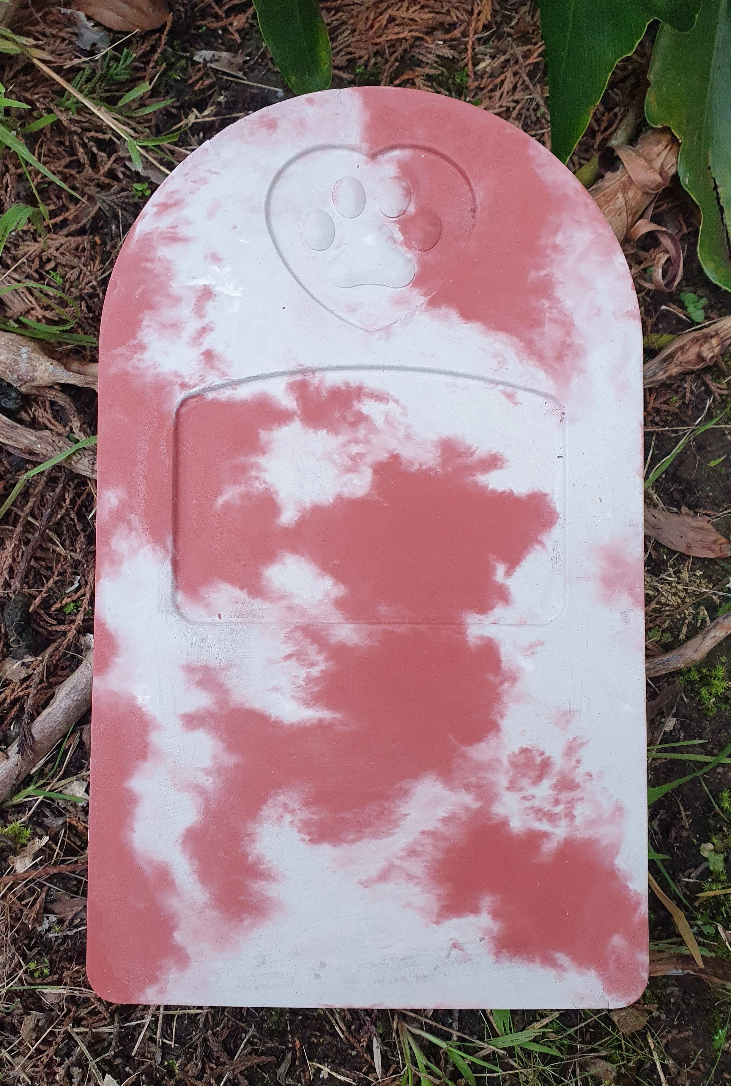 Pet memorial concrete stone in red and white colour, ready to be engraved.