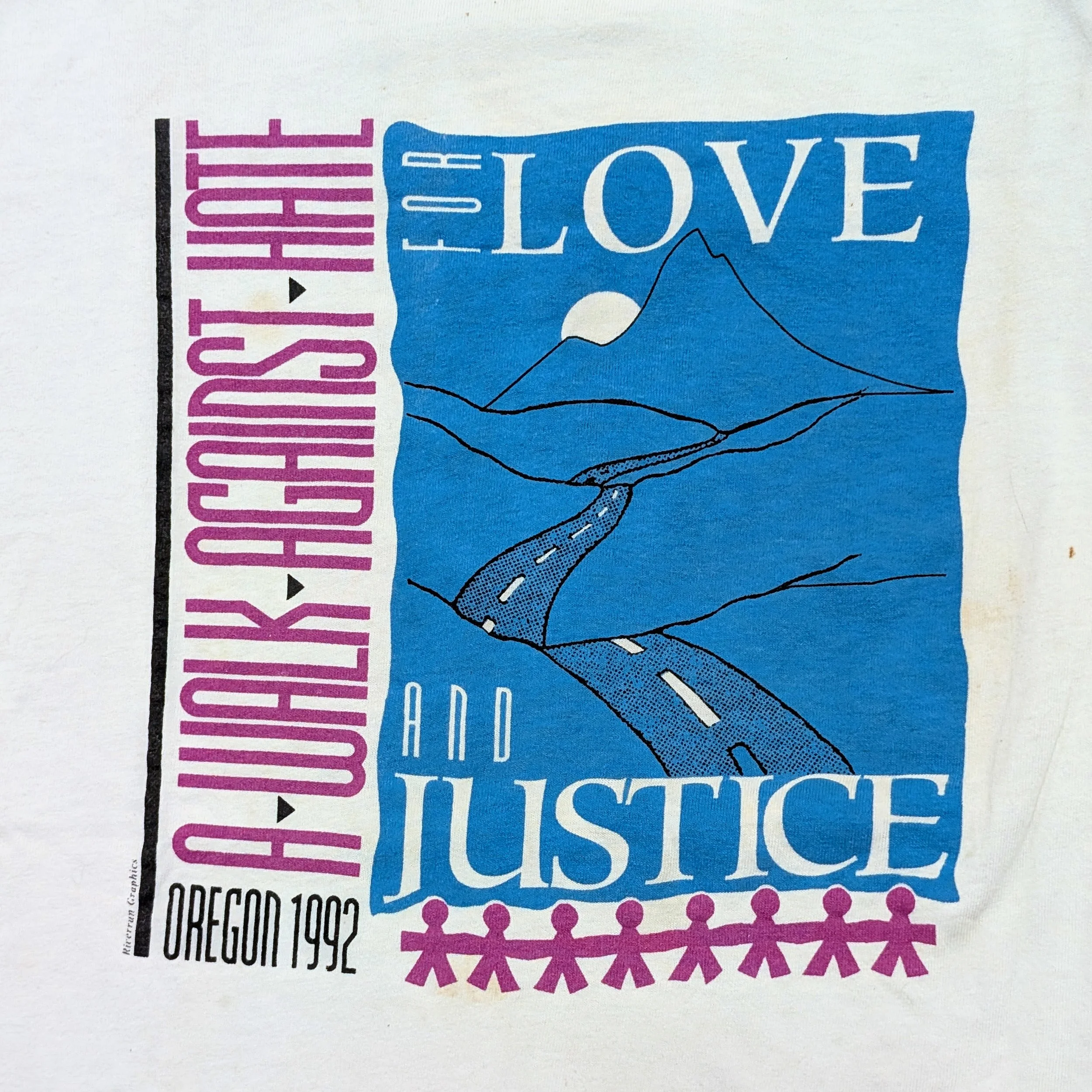 Close-up of a textured print with the text 'KINETIC LOVE' in large white letters on a blue background, with pink and black decorative elements and partial code or product information below.