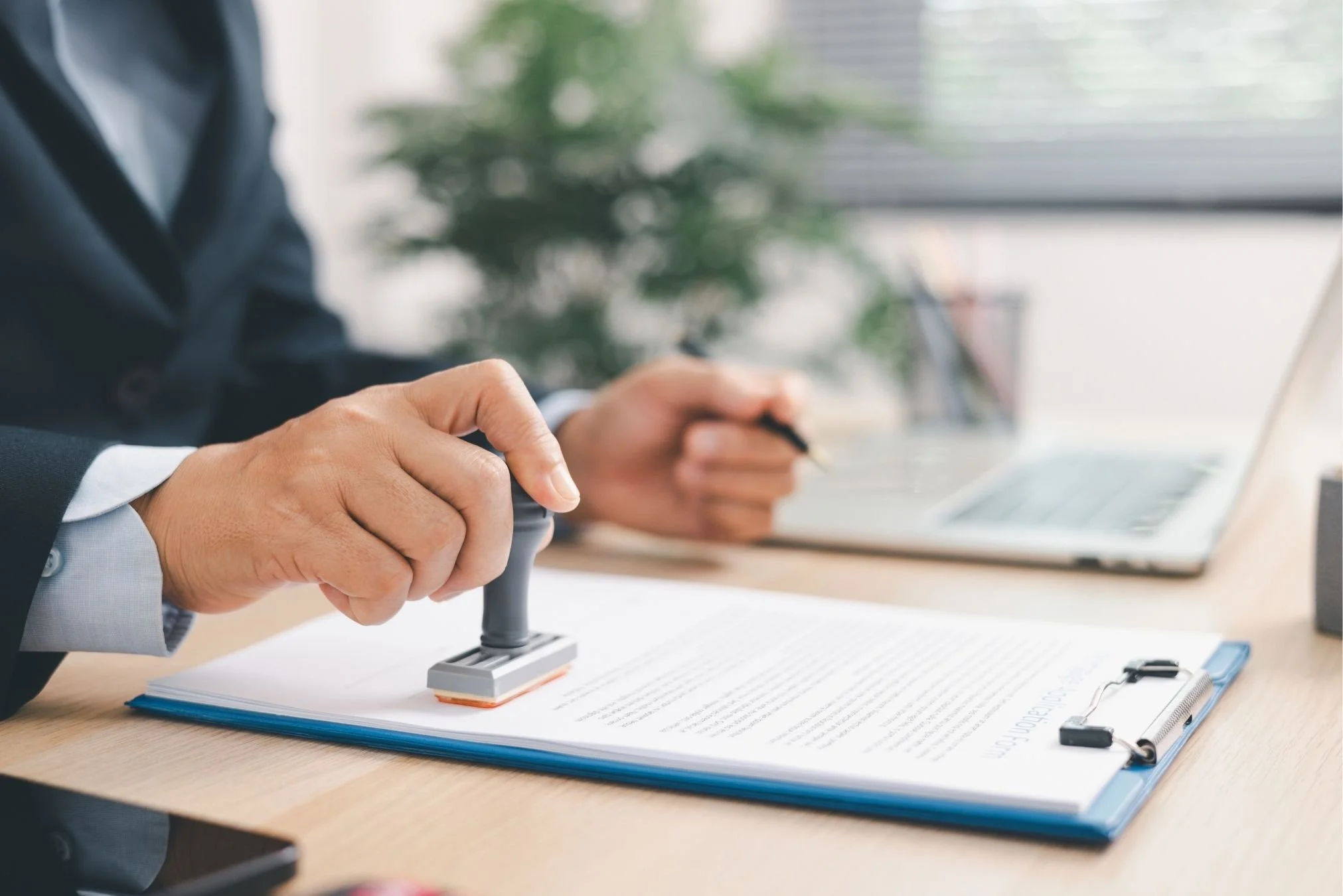 Insurance professional stamping policy documents for a trucking insurance brokerage serving commercial trucking companies.