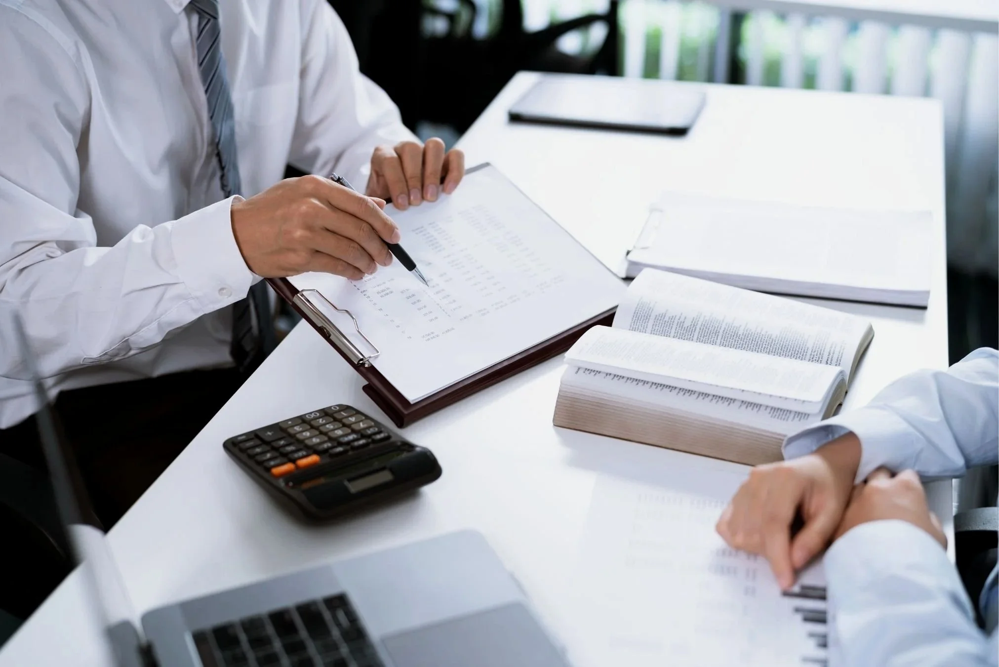 Insurance advisor reviewing coverage documents and policy details to help businesses evaluate average trucking insurance cost.