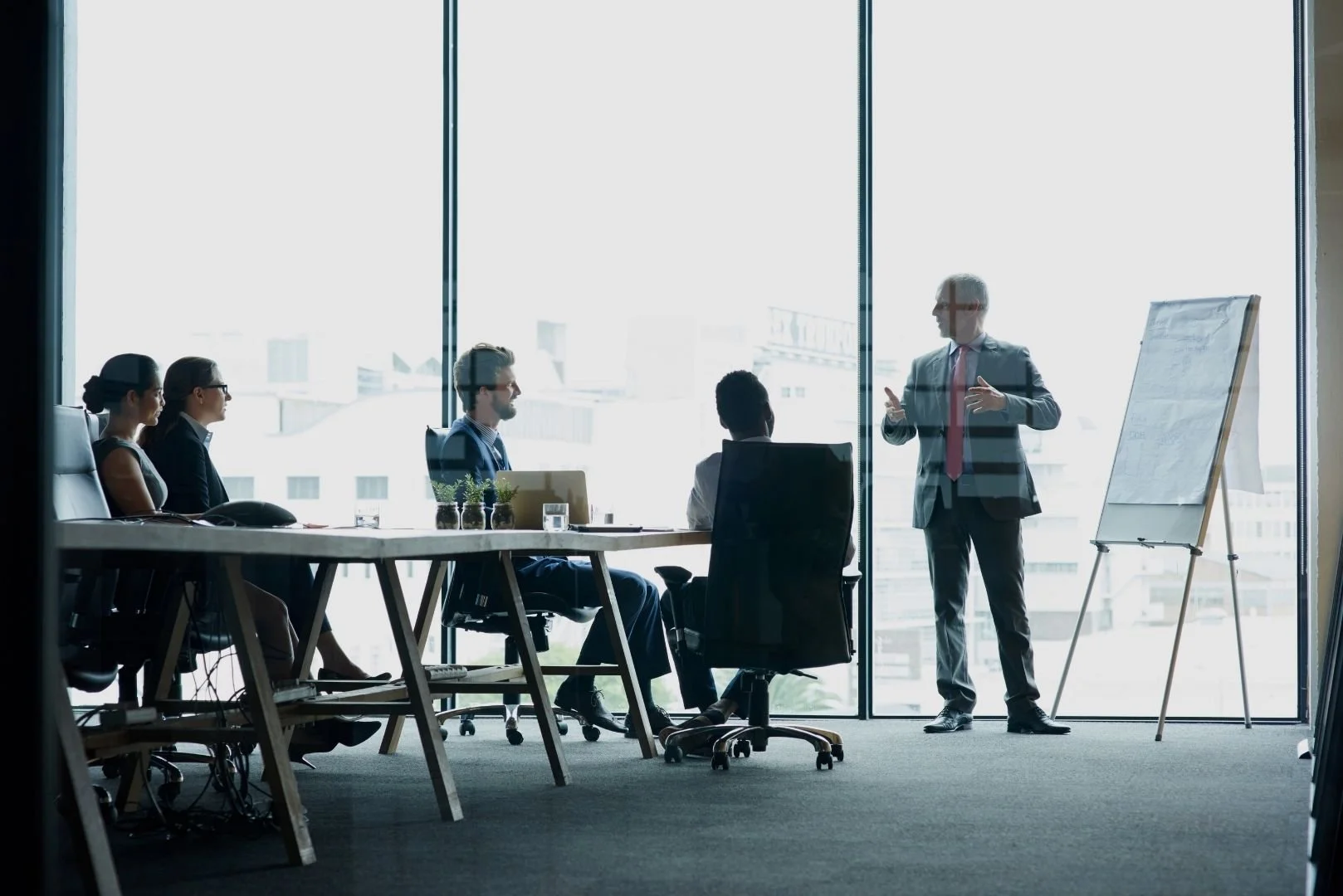 Executives meeting to review operational strategies and insurance planning with an experienced transportation insurance broker.