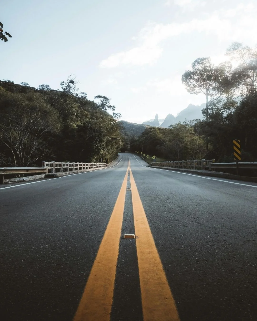 Open highway stretching through a mountain landscape, representing the routes protected by a trusted transportation insurance broker.