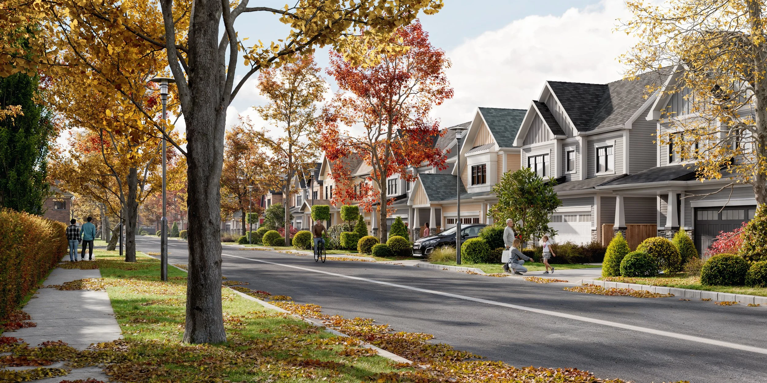 A suburban street lined with trees with fall foliage, people walking and biking, and modern houses with manicured lawns.