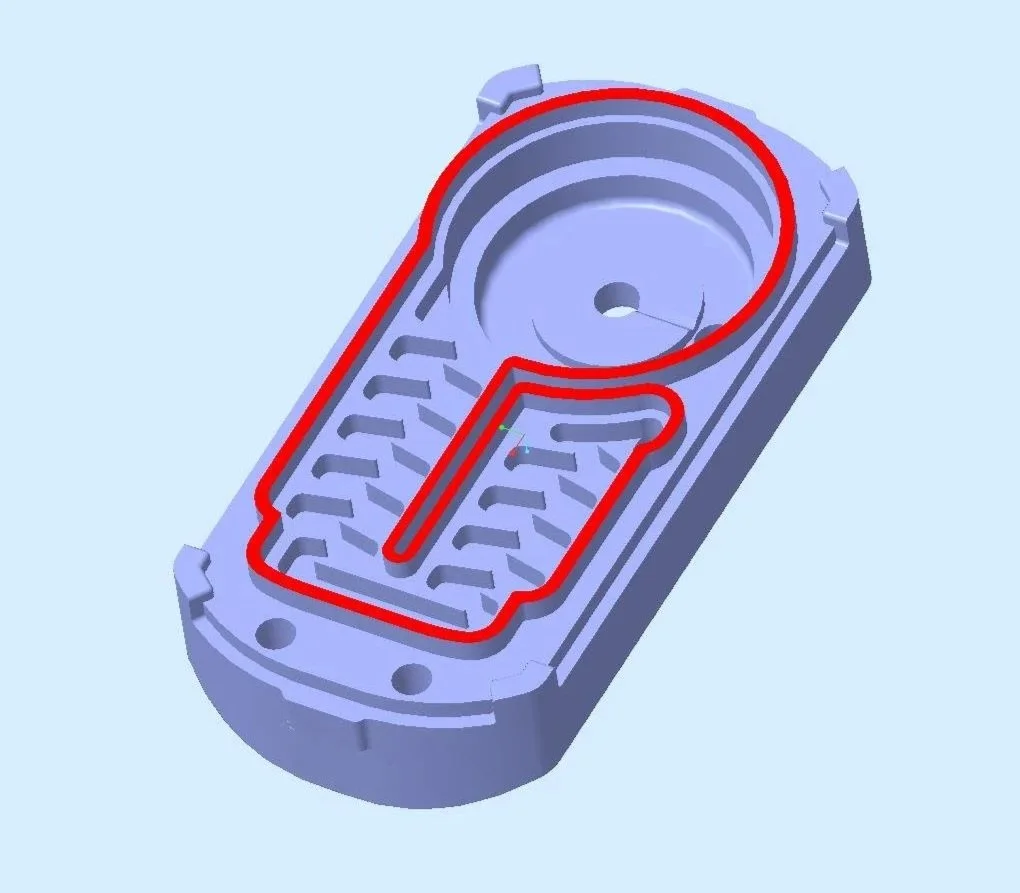 Computer-aided design model of a mechanical part with a red path highlighting a specific track or route on the surface.