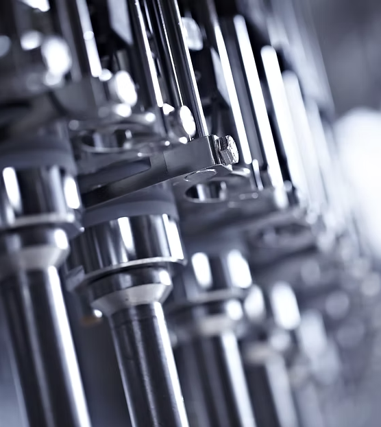 Close-up of industrial machinery or mechanical components with metal rods and bolts.