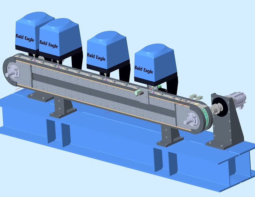 A mechanical device with four blue components labeled 'Bald Eagle', mounted on a metal frame with a gear mechanism and set on a blue base.