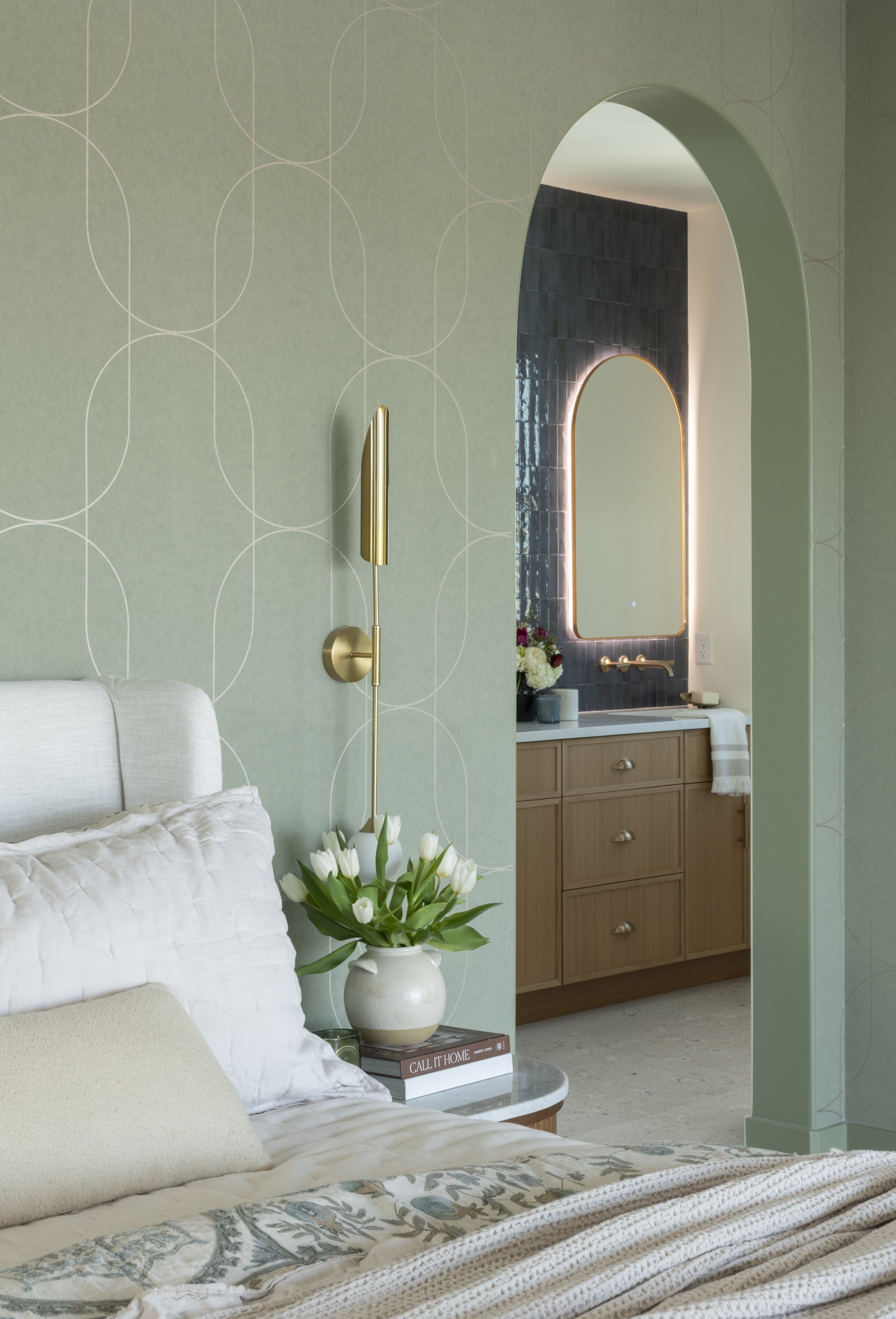 Thoughtfully designed primary bedroom with arched openings, custom cabinetry, and seamless connection to a luxury ensuite bath.