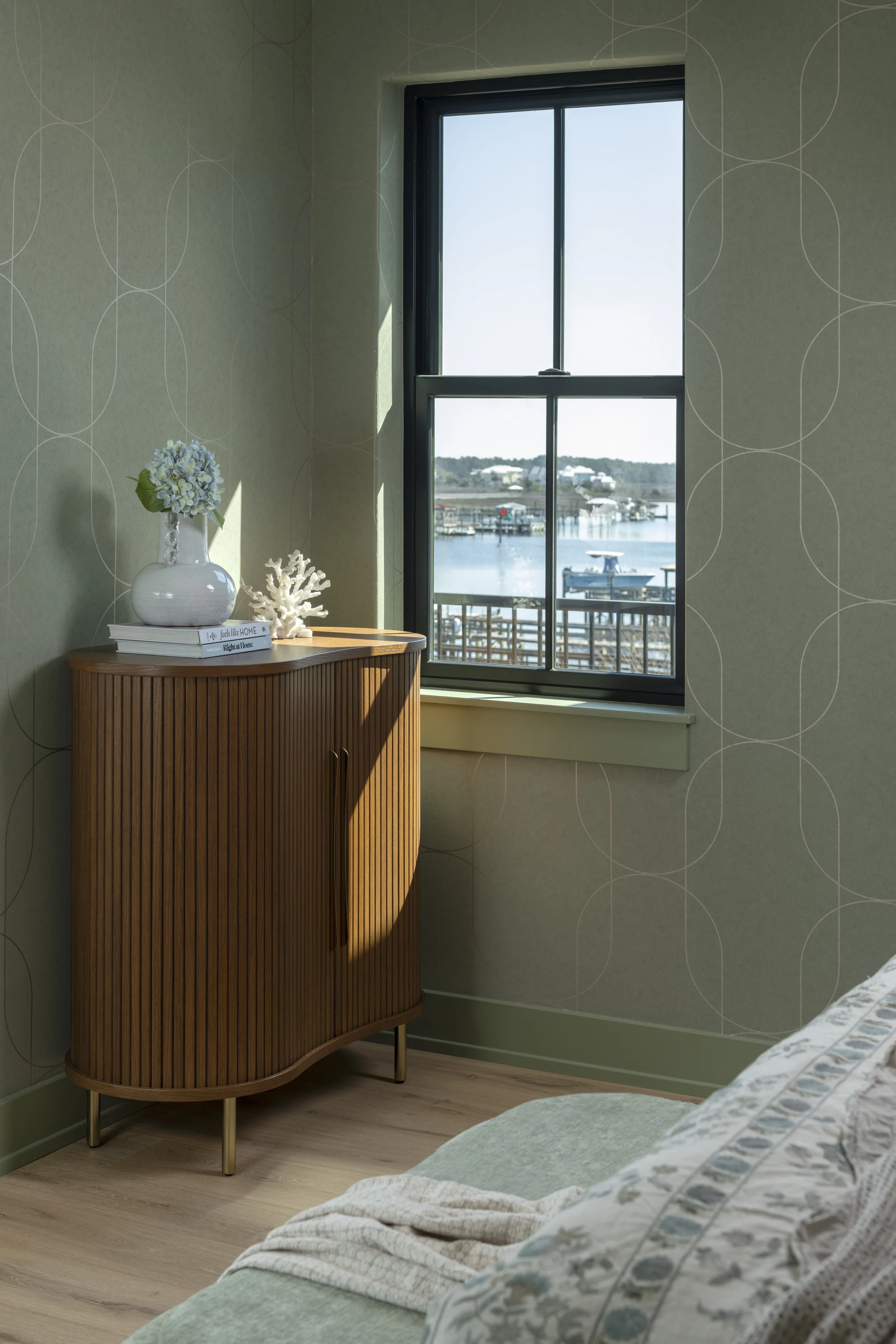 Elegant primary bedroom featuring custom design details, soft coastal color palettes, and handcrafted finishes.