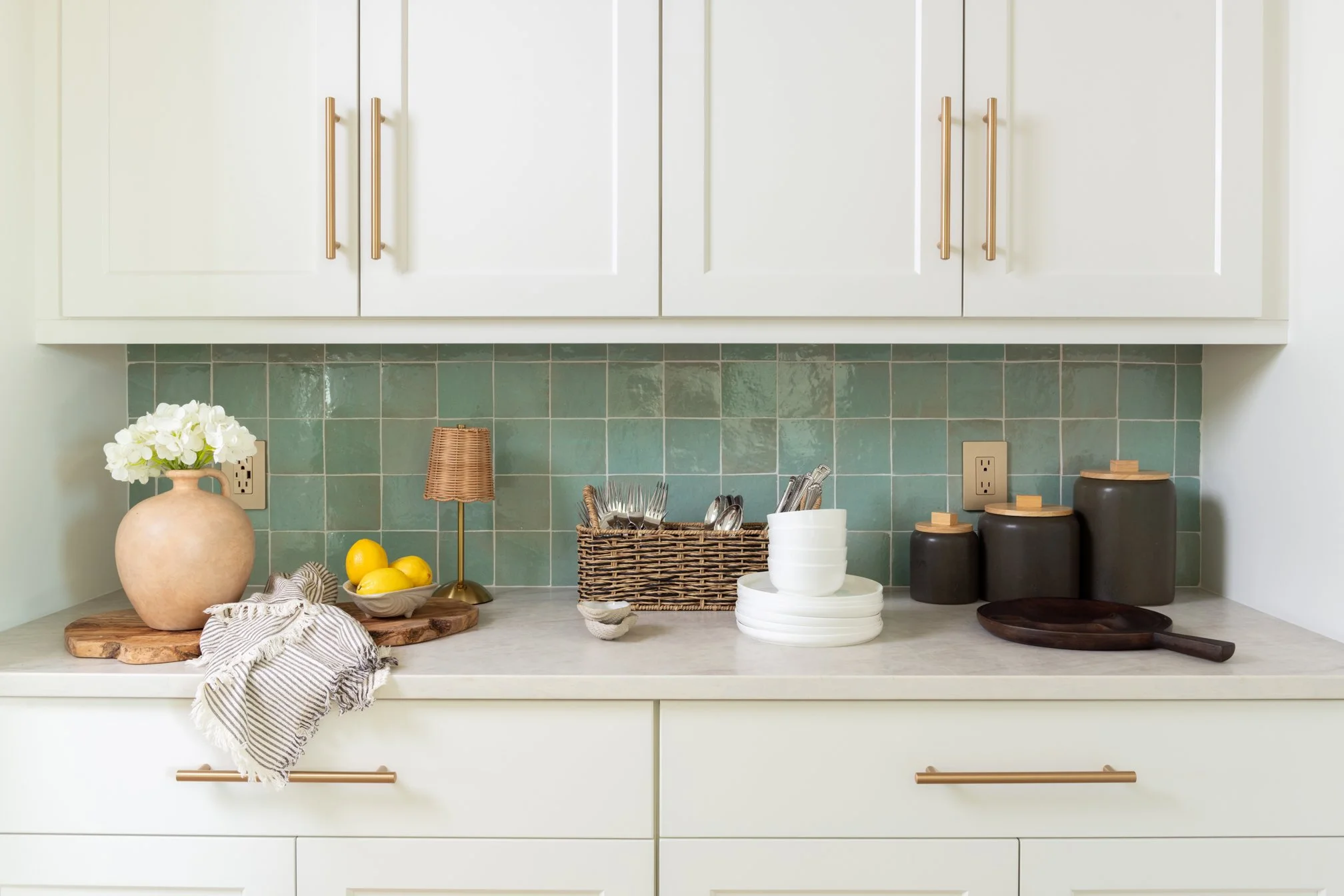 Designer kitchen vignette showcasing handcrafted cabinetry, artisan tile, and elevated coastal finishes.