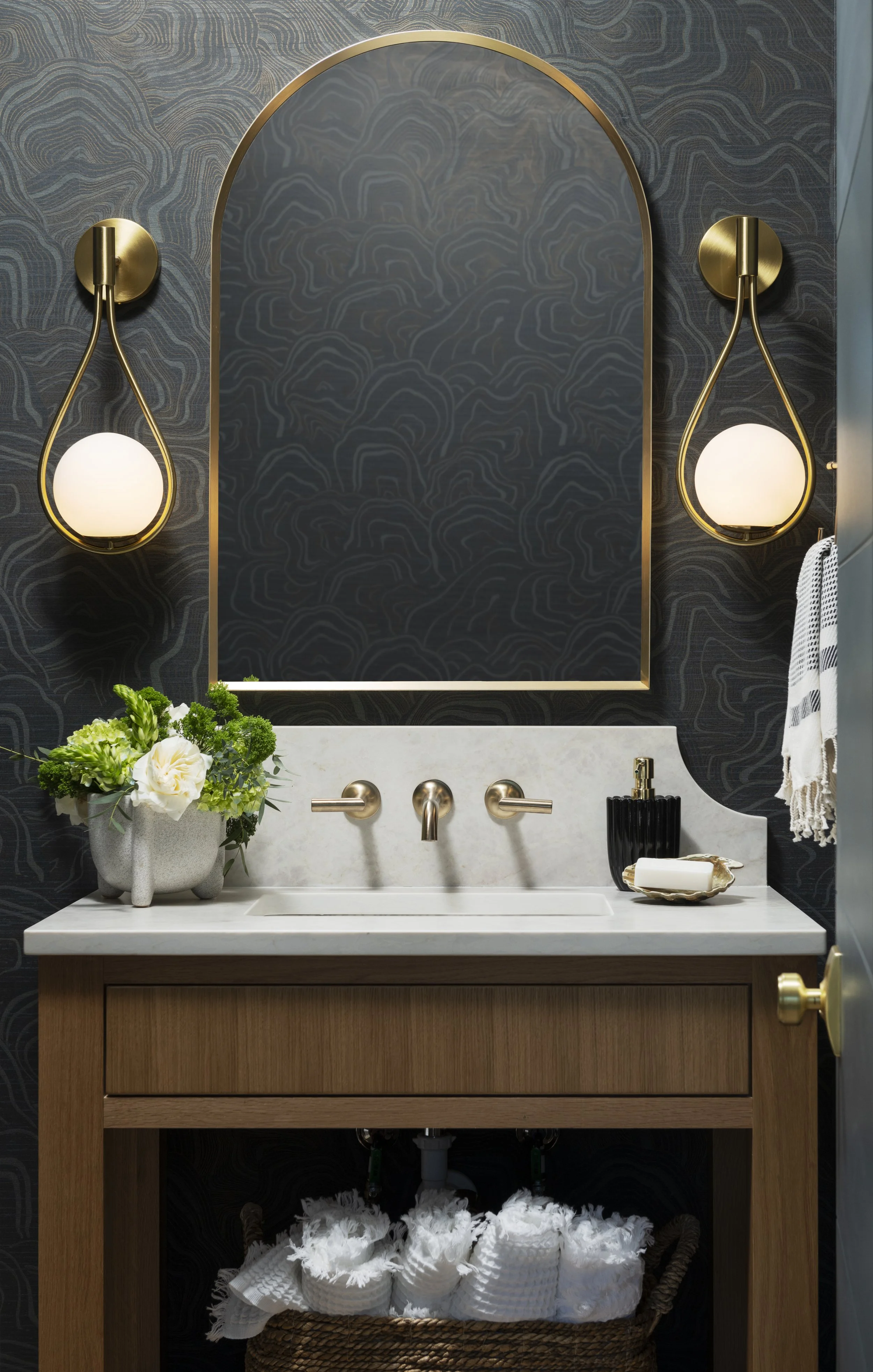 Powder Bath with Custom Vanity
Luxury powder room featuring a custom walnut vanity, arched brass mirror, designer wallcovering, and elevated coastal-inspired finishes in a custom Wilmington, NC home.