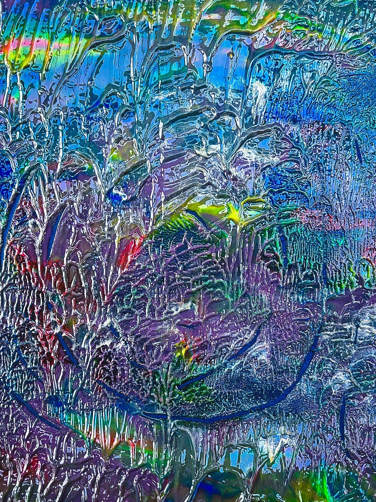 Colorful abstract pattern resembling water or ice, with swirling lines and vibrant hues of blue, purple, green, and hints of red and yellow.